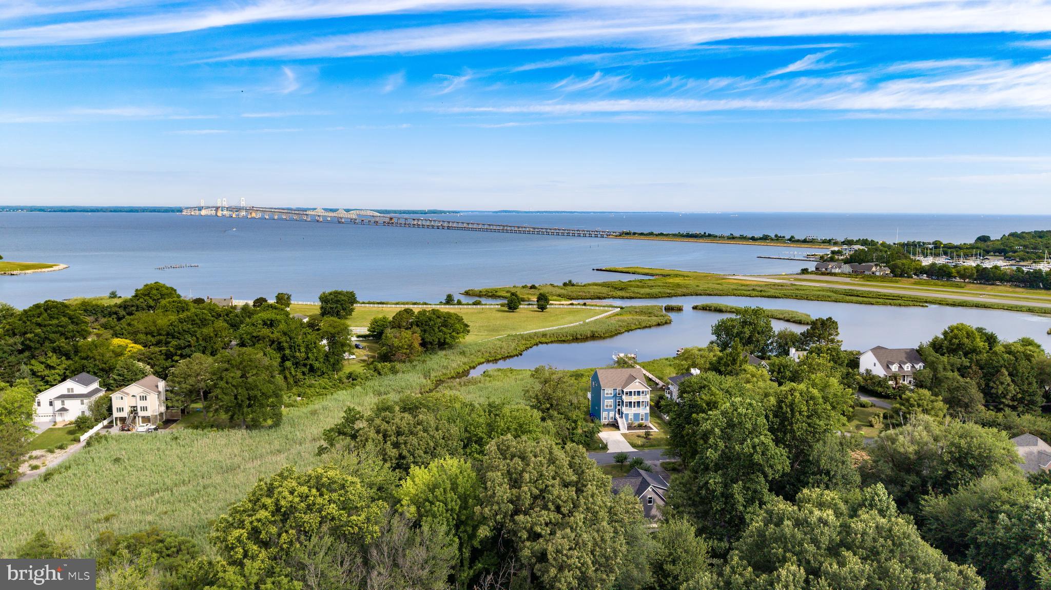 Experience some of the most captivating views the Chesapeake Bay has to offer. Perfectly positioned at the first exit off the Bay Bridge, this waterfront property showcases sweeping water views, stunning sunrises, and a front-row seat to the iconic Chesapeake Bay Bridge.
The shoreline is ideal for enjoying the Bay lifestyle-launch a kayak, paddleboard, jet ski, or small skiff right from your backyard, spend the day fishing or crabbing, and unwind while watching the backdrop of the Bay Bridge.
Like new construction this home was built just three years ago, this remarkable home offers 9 bedrooms plus a den, this includes a private 4-bedroom in-law suite with its own full kitchen and entry perfect for in-laws, guests or even its own apartment. Public water and public sewer provide added convenience, while the location offers easy access to shopping, dining, and everyday amenities without ever having to navigate Route 50.
Whether you're seeking a waterfront family compound, vacation getaway, or year-round residence, this property combines modern living, unmatched convenience, and unforgettable Chesapeake Bay views.
Lot next door is included in sale giving home just under 1 acre.
