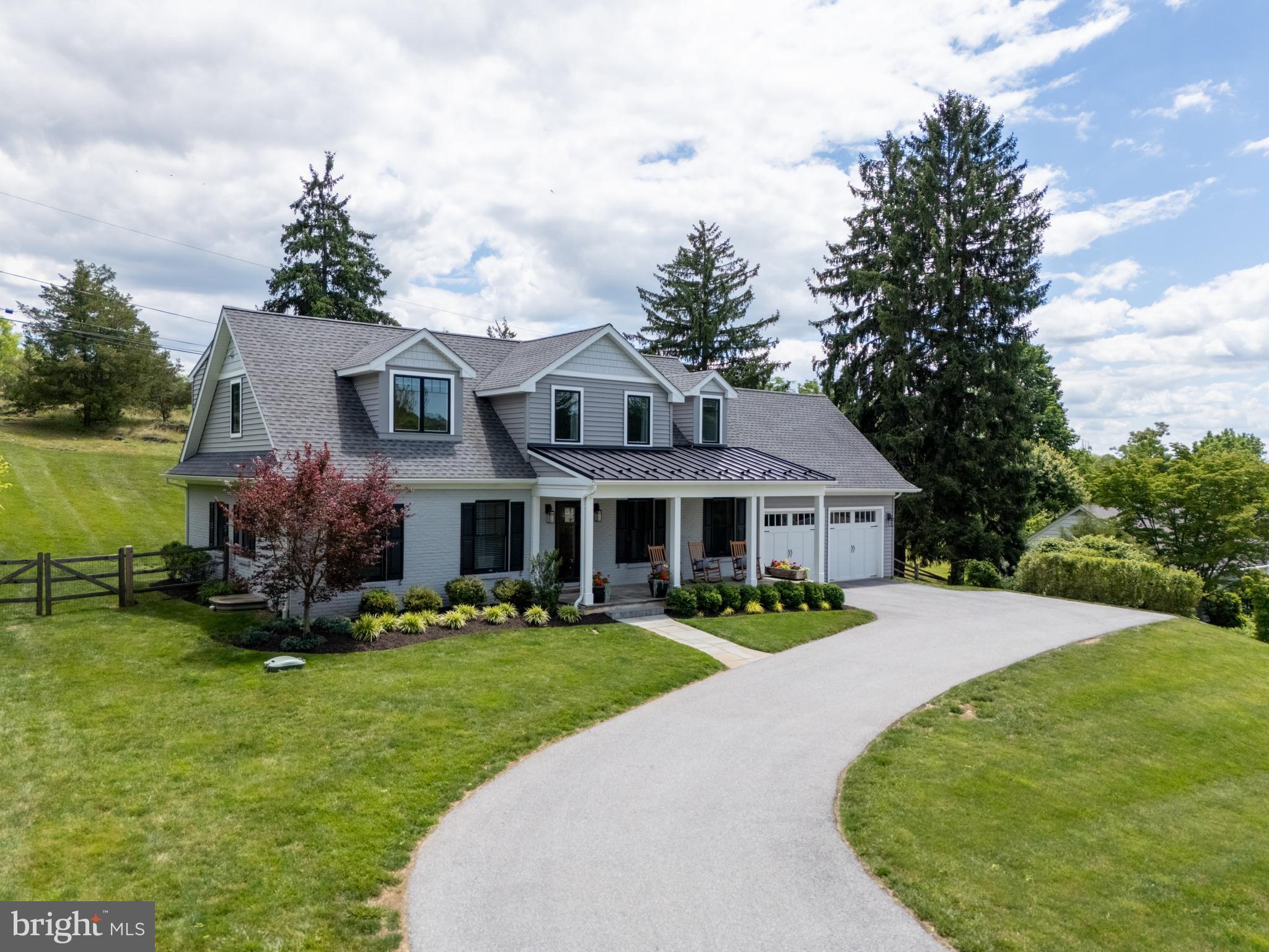 This is inspired living – a completely remodeled gem of a home that combines open concept design with immaculate finishes, and also gives you the ability to set up a 1st-floor bedroom suite. Step into the main living space, which offers a panoramic feel with focal points that include the stunning chef’s kitchen and a stone fireplace with built-in bookshelves on either side. Thoughtfully placed windows draw your eye even further out, enhancing the sensation of warmth and open space, while also providing beautiful natural light from every direction. If you’re looking for a bit of privacy, or a space to set up a home office, or a 1st floor bedroom, there’s a wonderful suite of rooms at one side of the home that offers all this versatility, and also includes a lavish full bathroom. Even the mudroom is designed to the nines, with built-in storage and direct access to the back patio. The theme of luxe design continues upstairs with a primary bedroom suite that features a sophisticated spa bathroom, 2 massive walk-in closets, and walk-in attic storage. At the far end of the hallway, the 2 hall bedrooms are both incredibly spacious and the stylish hall bathroom features a long vanity with plenty of storage and 2 sinks.  Downstairs, the finished walk-up basement will quickly become your game day and movie night destination with a built-in bar, great room, another full bathroom, and so much storage. Take the fun outside to enjoy the slate patio on a wonderfully private lot with mature trees, excellent privacy, and a gently sloping hill as the backdrop. The North Hill community offers a voluntary Civic Association that takes care of the private community lake. What a serene setting! Tucked onto a circular drive with no through-traffic, you’ll enjoy seamless access to Rte 322 and major commuter routes with the vibrant scene of downtown West Chester Boro just a stone’s throw away. What a rare find, combining location, floorplan and style. Request a personal tour today!