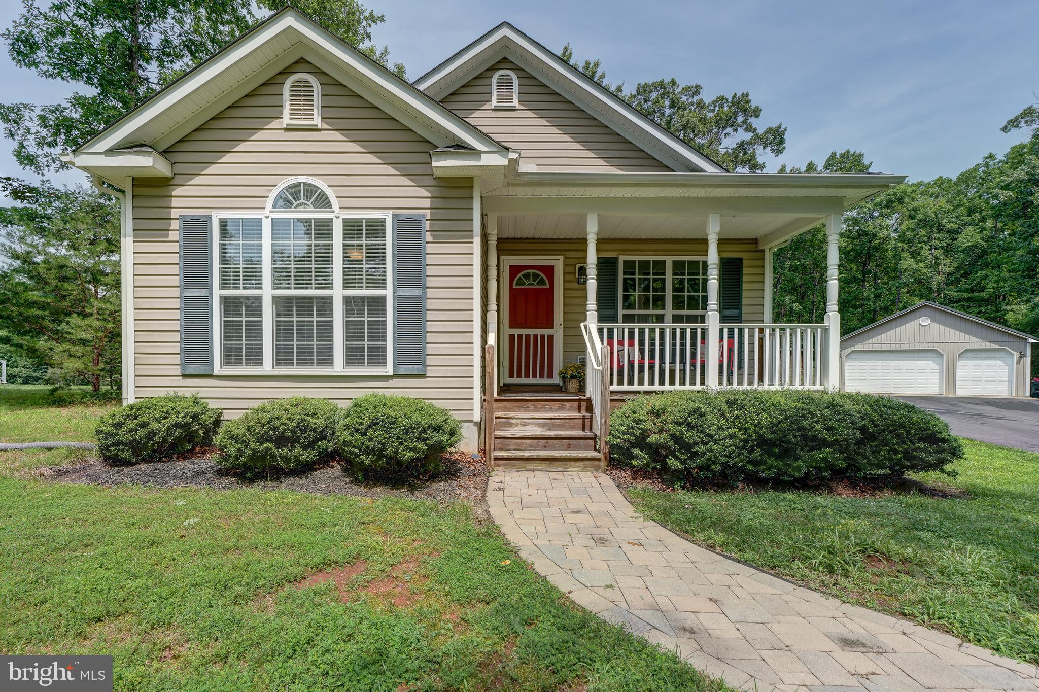 Welcome to your furnished Lake Anna getaway in the sought-after Oak Landing community on the public side of the lake! Whether you're looking for a full-time residence, weekend escape, or vacation retreat, this charming water access home is ready for you to start enjoying lake life from day one. Set on a beautifully manicured 0.94-acre lot with outstanding curb appeal and a paved driveway. Inside, you'll find an inviting open floor plan designed for easy everyday living and entertaining. The spacious family room flows seamlessly into the kitchen, featuring upgraded cabinetry, stainless steel appliances, and a dining area where everyone can gather after a day on the water. Offering 3 bedrooms and 2 full bathrooms, there's plenty of room for family and guests, and the washer and dryer convey for added convenience. Step outside to the expansive deck, the perfect place to fire up the grill, host summer cookouts, or simply relax and enjoy the peaceful surroundings. Need room for all your lake toys? The impressive 30x40 detached garage provides abundant space for your boat, jet skis, vehicles, workshop, or additional storage. Oak Landing offers exceptional amenities, including a deep-water swimming area, pavilion with picnic tables and grills, a boat ramp, and boat slips and jet ski slips available on a first-come, first-served basis with plenty available for residents to enjoy. Centrally located on the public side of Lake Anna, you're just minutes from the Lake Anna Food Lion shopping center, waterfront restaurants, marinas, breweries, wineries, and everything the lake has to offer. If you've been searching for an affordable, move-in-ready Lake Anna retreat that comes furnished and lets you start enjoying the lake immediately, this is the one. Don't miss your opportunity to make every weekend feel like a vacation!