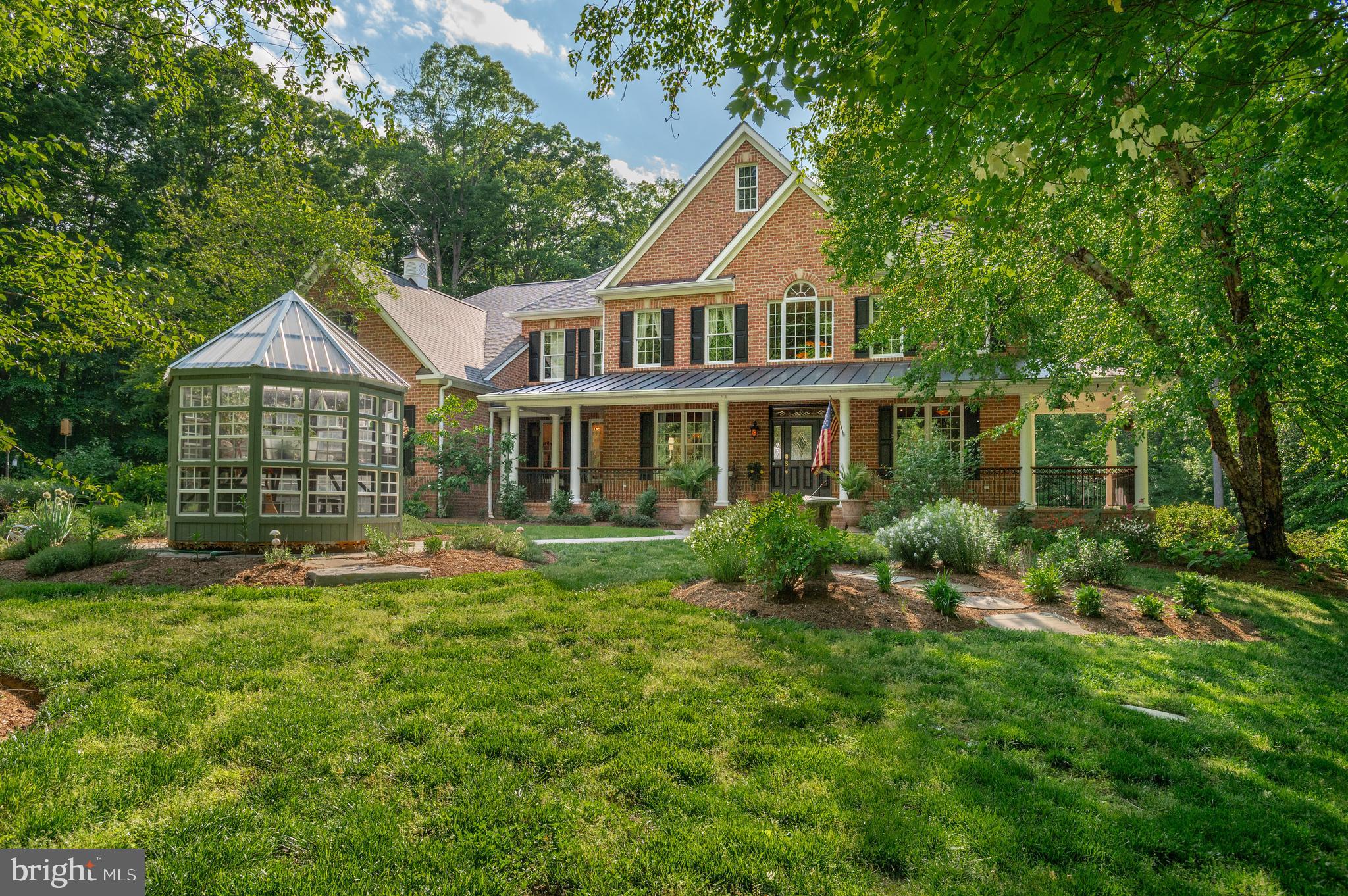 Luxury Living Meets Enchanted Woodland Oasis
“Enchanted” and “magical” are words that get thrown around in real estate until they lose their meaning. Here, in Davidsonville—just minutes from historic Annapolis and within easy reach of both Washington, DC and Baltimore—they’re simply accurate.

Set on 4.92 private acres, this 7,108‑square‑foot estate offers four bedrooms, five full bathrooms, a dedicated office, fitness space, and an additional 2,000‑square‑foot finished lower level. The home offers a rare combination of refined living, thoughtful updates, and true privacy—without giving up connection to the world beyond it. Annapolis, with its waterfront, dining, and cultural life, is right up the road. DC and Baltimore are each an easy commute away. And yet, once you turn down the drive and the property opens up around you, the outside world truly falls away.

The grounds themselves are an experience. Designed and maintained by the celebrated Homestead Gardens—with ongoing professional maintenance included through the end of the year—the landscaping here is not an accessory but a defining feature. A heated saltwater gunite pool (2019) catches the afternoon light. A fire pit marks the transition from manicured gardens to wooded acreage, where a path leads to Flat Creek. A conservation easement protects the surrounding woods, ensuring the natural setting remains forever preserved. A butterfly boardwalk (2021) winds from the gardens to the pool along the edge of the woods—an uncommon and charming feature of the landscape. And yes, there are chickens—because even estate living should have a bit of charm.

Inside, the home pairs scale with craftsmanship and makes a strong first impression. A grand entry foyer is flanked by a formal dining room, a generously scaled living room, and a classic wood‑paneled office, ideal as a dedicated workspace or library. The main level offers exceptional flow for both daily living and entertaining, supported by two powder rooms, a spacious laundry room, and a well‑appointed pantry alongside a butler’s pantry, all thoughtfully positioned just off the gourmet kitchen. The screened‑in porch, featuring a wood‑burning fireplace, is one of those rare spaces that works beautifully in every season.

All four bedrooms are generously sized and fully en suite, offering comfort and privacy for everyday living and guests alike. The primary suite features a fireplace and a fully renovated, spa‑caliber bath designed at the highest level, centered around a Japanese hot/cold soaking tub. It’s a space that feels less like an en suite and more like a private wellness retreat—luxury meant to be lived in.
The walk‑out lower level adds approximately 2,000 finished square feet, distinguished by unusually high ceilings and abundant natural light. Flexible finished spaces easily accommodate a home gym, media room, play space, studio, or wine‑theater lounge—ready to serve today, with room to adapt as life evolves.
Minutes to Annapolis. An easy commute to Washington or Baltimore. And yet, once you’re here—fire going, woods behind you, pool reflecting the last light of day—none of it feels remotely close. That is the rare gift of 4.92 acres in Davidsonville. Enchantment, defined.

This is a property best experienced in person. Private appointments available.
