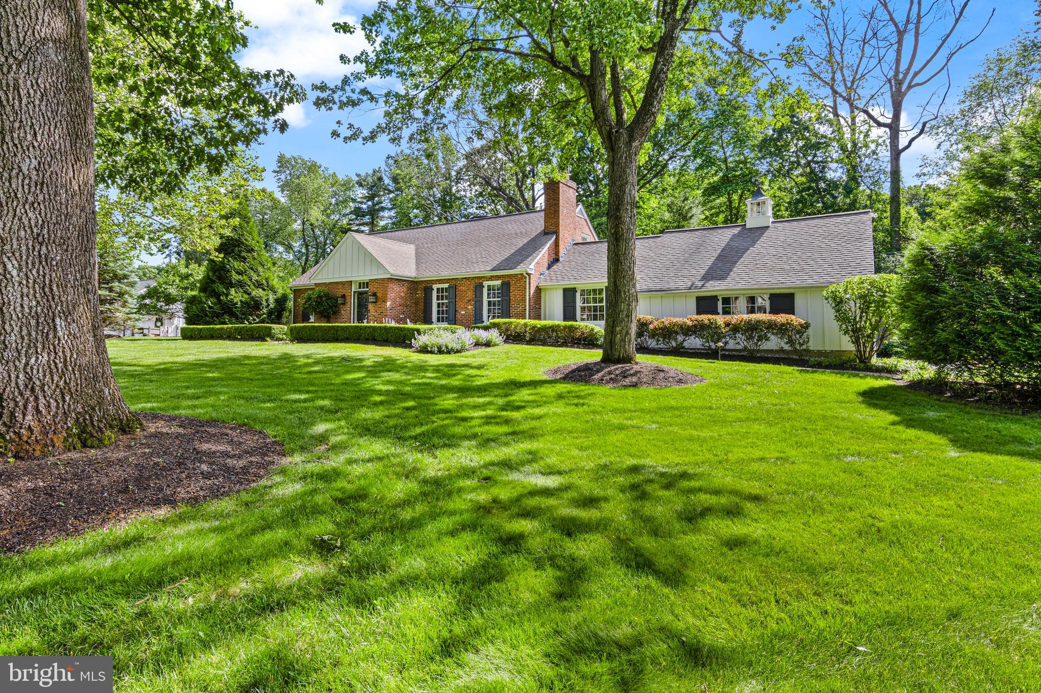 Nestled in Devon’s highly sought-after Shand Tract neighborhood, this beautifully renovated 4-bedroom, 3-bath Cape Cod offers the perfect blend of timeless character and modern living. Situated on one of the community’s most desirable lots, the home features an expansive, fully fenced, level rear yard and beautifully landscaped grounds. Thoughtfully redesigned to create open, functional living spaces, the home showcases a seamless flow between the gourmet kitchen, dining area, and great room — ideal for today’s lifestyle. The stunning kitchen is appointed with a large center island with breakfast bar seating, soapstone countertops, premium appliances, custom wood cabinetry, hardwood flooring, and recessed lighting throughout. The spacious living and dining areas are filled with natural light and anchored by a wood-burning fireplace, while sliding doors open to an exceptional outdoor entertaining space including stone patio and firepit. The inviting family room with gas fireplace offers an additional gathering space and the perfect setting for relaxing and entertaining. As you step outside, you will truly be wowed by the expansive, flat, open rear yard perfect for game playing, sports and entertaining. There is mature landscaping and fencing around the perimeter that provides exceptional privacy and tranquility as well. The first-floor primary suite offers flexibility and comfort, complete with a beautifully updated ensuite bath featuring a walk-in shower, marble flooring and countertops, plantation shutters, and a linen closet. A spacious second bedroom and updated full hall bath with soapstone finishes and a stylish vessel sink complete the main level. The second floor offers two additional generously sized bedrooms, all featuring ceiling fans and walk-in closets, along with a full bath, cedar closet, and numerous additional storage closets. The nicely finished lower level provides outstanding recreation space with ample room for a TV viewing area, pool table, playroom, gym, or home office. A large storage room and utility area add even more functionality. Extensive basement waterproofing has also been completed, creating one of the driest basements you will find. Additional highlights include a whole house generator with transfer switch, timeless plantation shutters, hardwood floors and  recessed lighting throughout, a whole-house attic fan, a water filtration system, and a salt free water softener and approximately 700 additional square feet of finished lower-level living space. Located within the top-ranked Tredyffrin-Easttown School District and just minutes from downtown Wayne, Trader Joe’s, Whole Foods, Lifetime Fitness, and SEPTA Regional Rail, this exceptional home offers unmatched convenience for shopping, dining, and commuting. Combining charm, quality craftsmanship, thoughtful updates, and an unbeatable neighborhood setting, this truly move-in-ready home is a rare offering in one of the Main Line’s most cherished communities. Showings begin Wed., June 3rd at 8am.