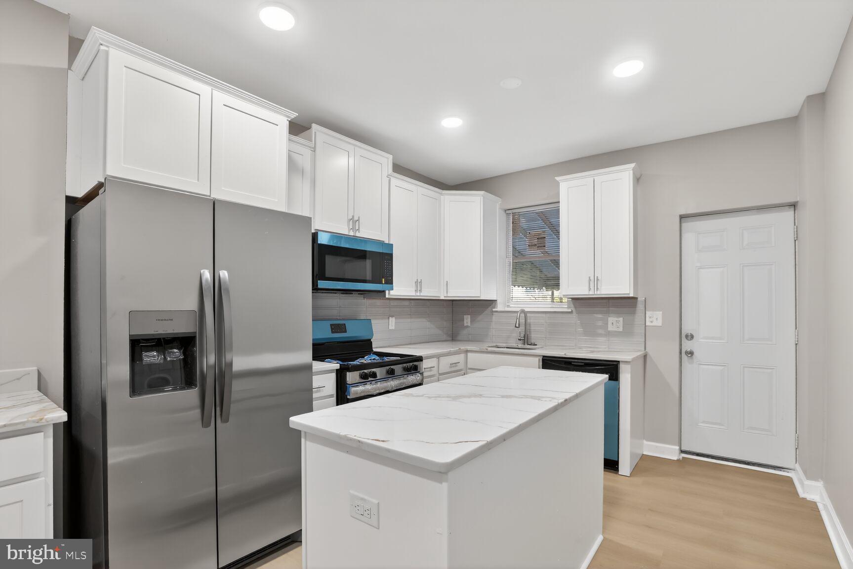 Welcome to 504 E 43rd Street — a beautifully renovated 3-bedroom, 2.5-bath townhome located just minutes from Johns Hopkins , Loyola, Morgan & Towson Universities. Fully, updated with permits, this home offers modern living with a spacious, open-concept design and high-quality finishes throughout. Step inside to a bright and inviting main level featuring new flooring, recessed lighting, and an expansive living area ideal for entertaining. The open layout flows seamlessly into the dining space and the stunning gourmet kitchen, complete with white shaker cabinets, sleek tile backsplash, stainless steel appliances, a center island, and elegant quartz countertops. A convenient main-level half bath adds practicality and comfort — a rare upgrade in this neighborhood.  Upstairs, the oversized primary bedroom features its own private en-suite bathroom, beautifully appointed with marble-style tile, modern fixtures, and a glass shower — a standout luxury for homes in this area. Two additional bedrooms and a fully renovated hall bath provide plenty of space for guests, family, or work-from-home needs. The lower level offers a large, clean basement with endless potential for storage, a workshop, or future finishing. Outside, the fenced rear yard provides privacy and room to create your own outdoor oasis.