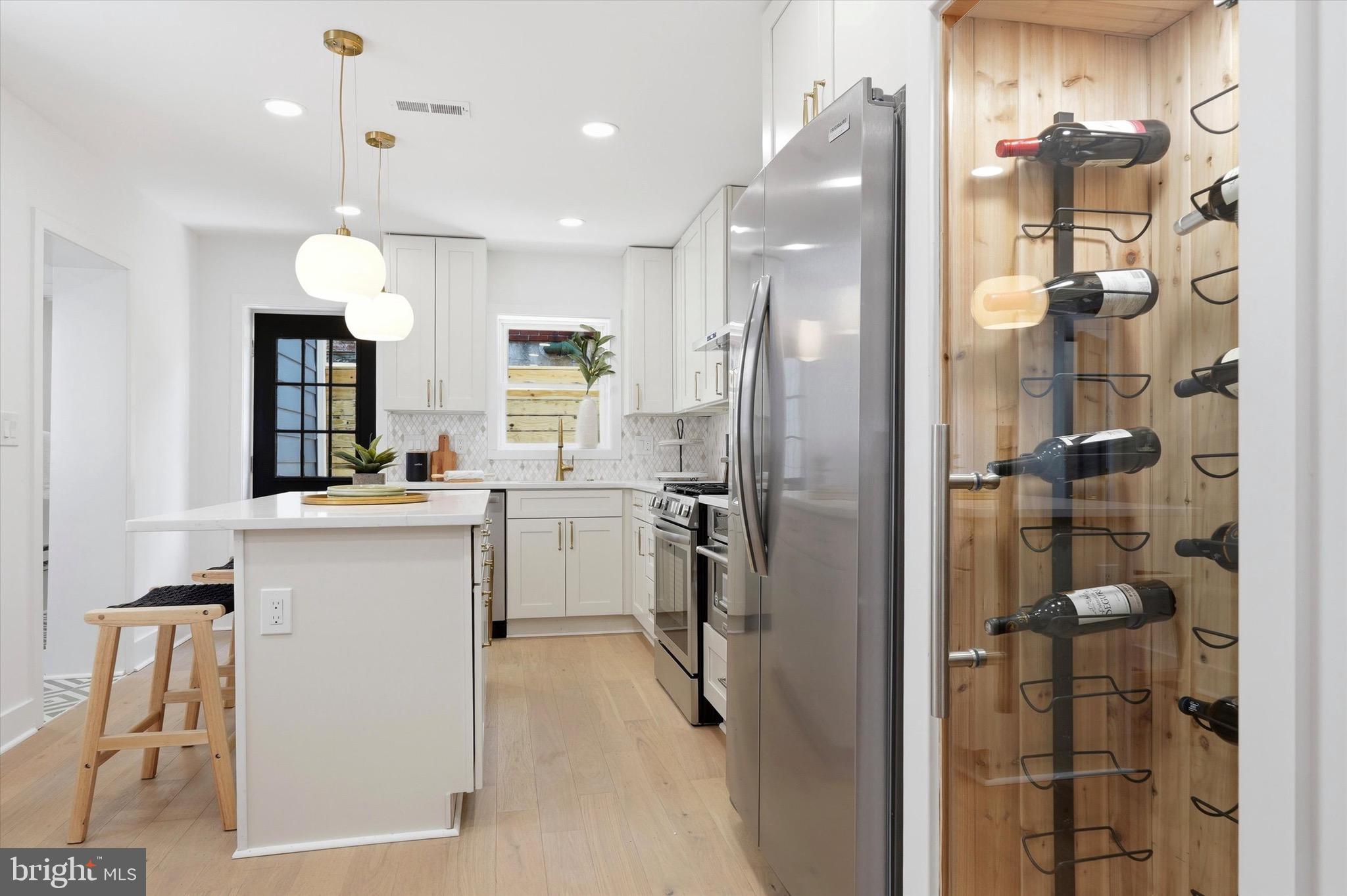 Stunning fully renovated 2-bed, 3-bath home in the heart of East Passyunk, South Philadelphia.
Set back from the street with a beautiful front porch, planter box, and hanging plants, this home offers curb appeal and a peaceful front yard. A convenient side alley keeps trash out of the main living areas.
Inside, you’ll find an open floor plan with exposed brick, wood beams, a kitchen island, custom wood shelving, sleek glass-enclosed cedar wine closet and the ever so rare coat closet.  Upstairs, both bedrooms have their own full bathroom and custom closets, with laundry conveniently located on the second floor. The finished basement adds flexible living space, and there’s a cute backyard in the rear. Every closet in the home is custom-built. Bright, modern, and move-in ready — just steps from everything East Passyunk has to offer!