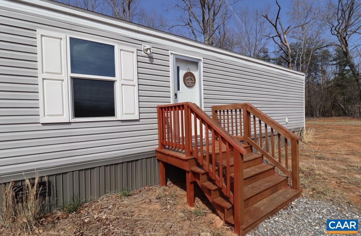 Charming Country Living on Nearly an Acre in Dillwyn, VA  Welcome to peaceful country living in the heart of Buckingham County! This immaculately maintained 3-bedroom, 2-bath manufactured home sits on a flat and usable 0.83-acre lot, offering the perfect blend of comfort, space, and affordability.  Step inside to find a functional layout with a spacious living area and open kitchen with ample counter space, and a primary suite featuring its own private bath. Two additional bedrooms provide flexibility for family, guests, or a home office.  Outside, enjoy the wide-open yard with woods on the back portion for quiet living. The flat lot makes maintenance easy and provides plenty of room for outdoor entertaining.   Located just minutes from the town of Dillwyn, this home offers a peaceful rural setting while still being an easy drive to Farmville, Scottsville and Charlottesville.