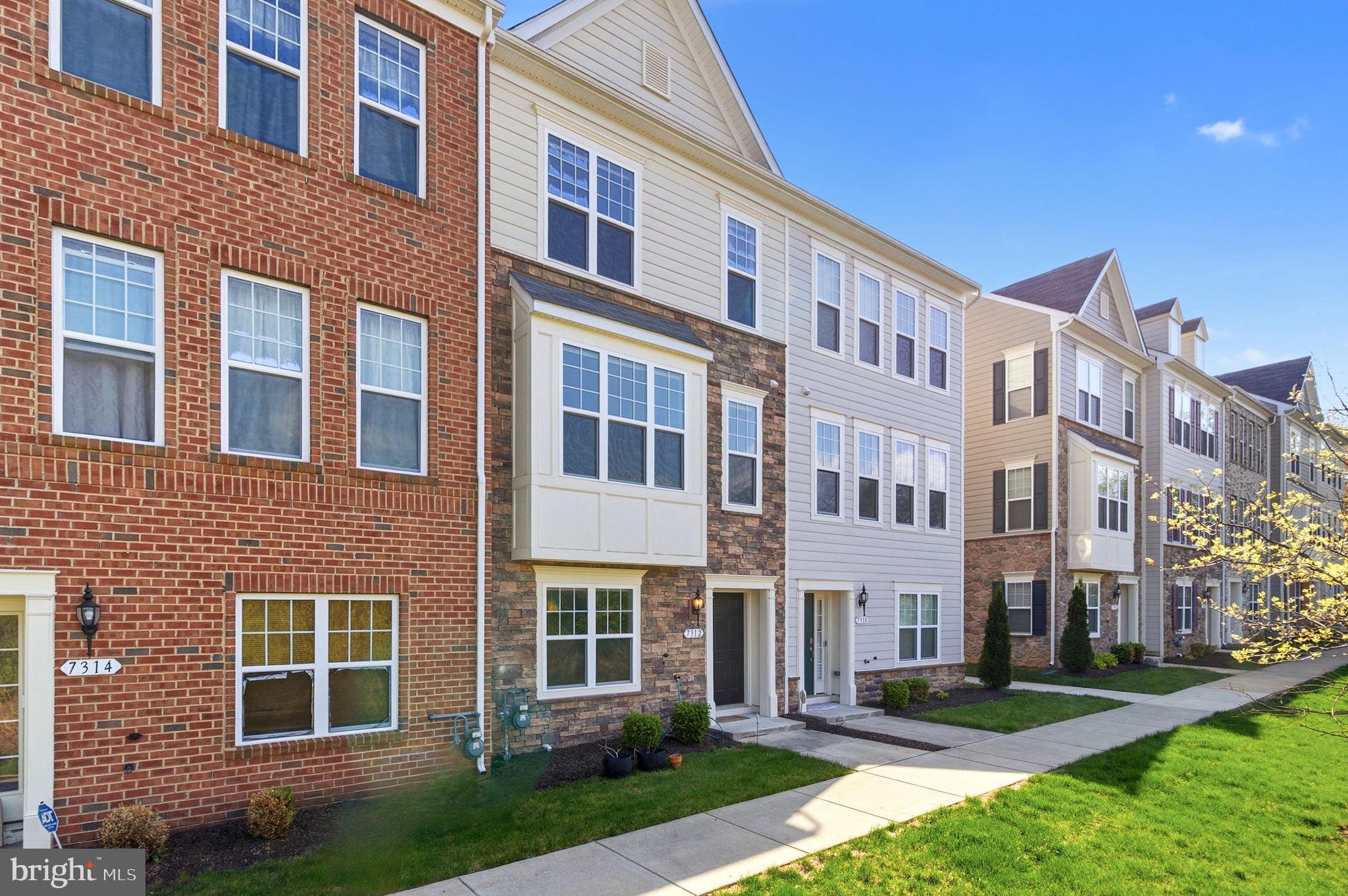 Step into 7312 Wood Trail Dr, a 4-level townhome in Lanham built just 6 years ago, featuring gleaming oak-tone floors, a chef's kitchen, a primary suite you won't want to leave, and a 4th-floor loft with its own rooftop deck.

Walk in from the street to a flexible entry level built for however you work or unwind — currently set up as a home office, but just as easily could be a den, gym, or guest space. A two-car garage and a half bath (already roughed in for a full bath, if you want to convert down the road) complete the level.

Upstairs, the main level is where the home really opens up. The living room flows straight into the kitchen and dining room in one connected, modern space — perfect for keeping the conversation going while dinner's on, or letting guests spread out without ever feeling shut off. Step out from the living room onto the deck for morning coffee or an evening wind-down. A generous pantry and a half bath for guests round out the floor.

The next level is where you unwind: a wonderful primary suite with a bathroom that includes double vanities and a custom-shelved walk-in closet that's basically its own dressing room — the kind of space that makes hitting snooze one more time feel justified. Down the hall, two more bedrooms share a full bath, and a laundry room keeps wash day off the stairs.

The top floor is pure bonus space — a private loft, already prewired for a full media setup, ready for family movie nights, a guest retreat, or your own entertainment lounge. Step outside and the rooftop deck adds a whole new dimension: your own perch above it all.

The details set it apart: oak-tone luxury vinyl plank runs through nearly the entire home, honeycomb blinds dress every window and door, and a clean eggshell painting finish that ties it all together. This home didn't stop at builder-grade — it kept getting better.

Schedule your private tour before this one's gone.