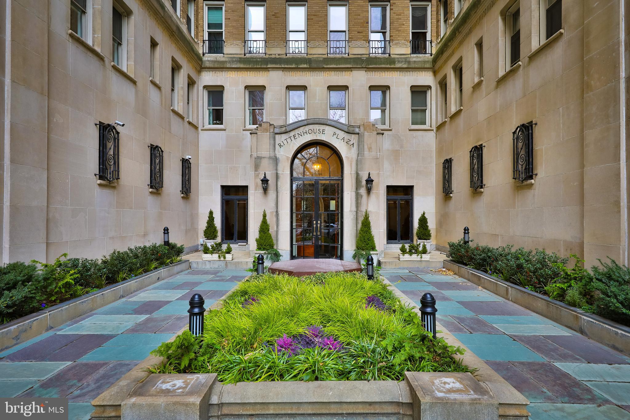 Perched on a high floor in the Rittenhouse Plaza, this corner one bedroom plus den, two bath residence offers exceptional light, space, and views in one of Philadelphia’s most sought-after locations on Rittenhouse Square. With three beautiful exposures, the home is filled with natural light throughout the day. The west-facing den enjoys lovely sunset views and features custom built-ins, creating an ideal office or sitting room. The expansive living and dining areas face north and east, capturing open skyline views and soft morning light. Original floors with mahogany inlay run throughout the home, adding timeless character and warmth. The generously sized kitchen offers gas cooking, side by side laundry, and ample workspace.    The spacious primary bedroom is both quiet and inviting, featuring built-in bookshelves and an en-suite bath with a window for natural light and ventilation. Storage is a standout feature of this home. A separate hallway offers four large closets and houses the second full bathroom, providing exceptional functionality. This residence presents a wonderful opportunity to customize a truly special home in one of Philadelphia’s rare New York-style prewar Co-ops. The Plaza is known for its classic architecture, private courtyard garden, attentive service, and unparalleled location. This pet-friendly building offers a 24 hour concierge and unmatched access to the best of Center City. The monthly co-op fee includes real estate taxes, Fios cable and internet, heat, water, sewer, and building maintenance. A one-time transfer fee equal to 2% of the purchase price is payable at closing. Nearby parking options are available for rent within one block.