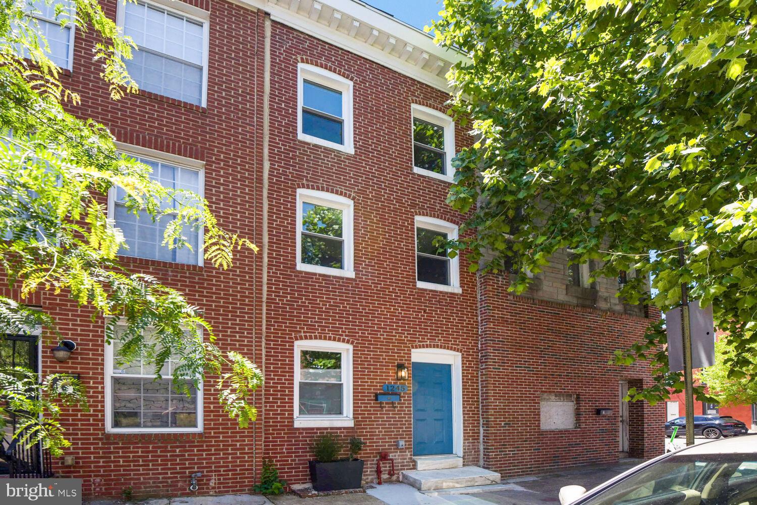 Welcome to 1245 Lombard Street, a beautifully renovated brick rowhome located in the heart of Baltimore’s historic Hollins Market neighborhood. Just a short walk from the University of Maryland Medical Campus and the University of Maryland BioPark, this spacious four-bedroom, two-full-bath residence offers the perfect blend of historic charm and modern updates. The inviting living room showcases exposed brick walls and abundant natural light, creating a warm and welcoming atmosphere. The renovated kitchen features quartz countertops, a classic subway tile backsplash, and ample cabinetry, with direct access to a large private rear patio—ideal for entertaining, outdoor dining, or relaxing with friends and family. Upstairs, you’ll find four bedrooms and two updated full bathrooms, complemented by exposed brick accents that add character throughout the home. The lower level provides valuable storage space and additional flexibility. Whether you’re searching for a primary residence or an investment opportunity near Baltimore’s major medical and educational institutions, this property offers exceptional value and convenience. Situated in the vibrant Hollins Market community, residents enjoy easy access to the historic Hollins Market, Baltimore’s oldest public market, as well as neighborhood parks, local restaurants, community events, and convenient transportation options. The location also provides quick access to Downtown Baltimore, Camden Yards, M&T Bank Stadium, the Inner Harbor, and major commuter routes. Known for its walkability and proximity to the University of Maryland campus, Hollins Market continues to attract homeowners seeking an authentic Baltimore neighborhood experience with urban convenience.
