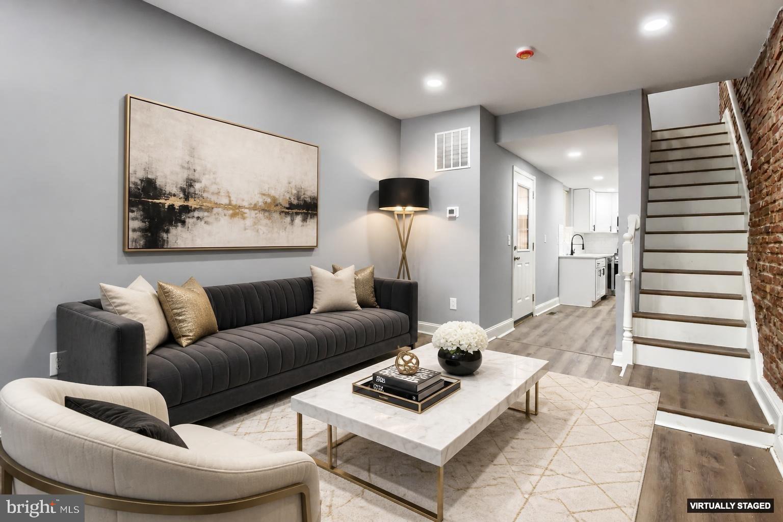 Welcome to 1245 Lombard Street, a beautifully renovated brick rowhome located in the heart of Baltimore’s historic Hollins Market neighborhood. Just a short walk from the University of Maryland Medical Campus and the University of Maryland BioPark, this spacious four-bedroom, two-full-bath residence offers the perfect blend of historic charm and modern updates. The inviting living room showcases exposed brick walls and abundant natural light, creating a warm and welcoming atmosphere. The renovated kitchen features quartz countertops, a classic subway tile backsplash, and ample cabinetry, with direct access to a large private rear patio—ideal for entertaining, outdoor dining, or relaxing with friends and family. Upstairs, you’ll find four bedrooms and two updated full bathrooms, complemented by exposed brick accents that add character throughout the home. The lower level provides valuable storage space and additional flexibility. Whether you’re searching for a primary residence or an investment opportunity near Baltimore’s major medical and educational institutions, this property offers exceptional value and convenience. Situated in the vibrant Hollins Market community, residents enjoy easy access to the historic Hollins Market, Baltimore’s oldest public market, as well as neighborhood parks, local restaurants, community events, and convenient transportation options. The location also provides quick access to Downtown Baltimore, Camden Yards, M&T Bank Stadium, the Inner Harbor, and major commuter routes. Known for its walkability and proximity to the University of Maryland campus, Hollins Market continues to attract homeowners seeking an authentic Baltimore neighborhood experience with urban convenience.