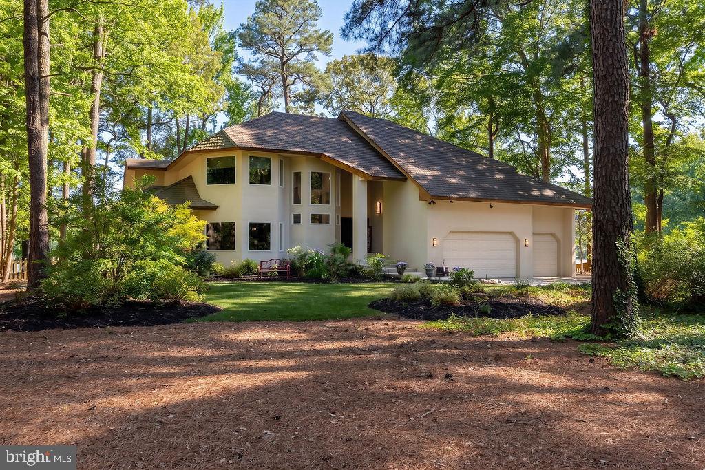 Welcome to 10708 Pine Island Drive, an exceptional custom-built coastal contemporary waterfront residence located in the highly sought-after community of Piney Island. Designed to embrace both luxury and the natural beauty of its surroundings, this meticulously maintained three-bedroom, two-and-one-half-bath home offers an unparalleled waterfront lifestyle. From the moment you step into the welcoming foyer, your eyes are immediately drawn through the home to breathtaking southern water views. Natural sunlight pours through expansive windows and walls of glass, while cool summer breezes flow effortlessly throughout the thoughtfully designed open floor plan.
At the heart of the home is an exquisite chef’s kitchen featuring high-end finishes, abundant workspace, and seamless connectivity to the living and dining areas—perfect for entertaining family and friends. The oversized sunroom serves as an extension of the living space, bathed in natural light from a bank of sliders that frame picturesque waterfront views year-round. Outdoor living is equally impressive. Expansive waterfront-facing decks flow gracefully from the home and blend seamlessly with professionally landscaped grounds. Follow the winding garden path to your private waterfront oasis complete with a dock overlooking the tranquil waters of Shingle Landing. Whether enjoying morning coffee, watching wildlife, boating, kayaking, or relaxing with an evening sunset, this property offers a lifestyle that few homes can match. Additional features include a spacious three-car garage, whole-house generator for peace of mind, generous storage, and quality craftsmanship throughout. Perfectly positioned in one of the area’s most desirable waterfront neighborhoods, this exceptional property offers the rare combination of luxury, comfort, and direct access to one of the Eastern Shore’s most scenic waterways.