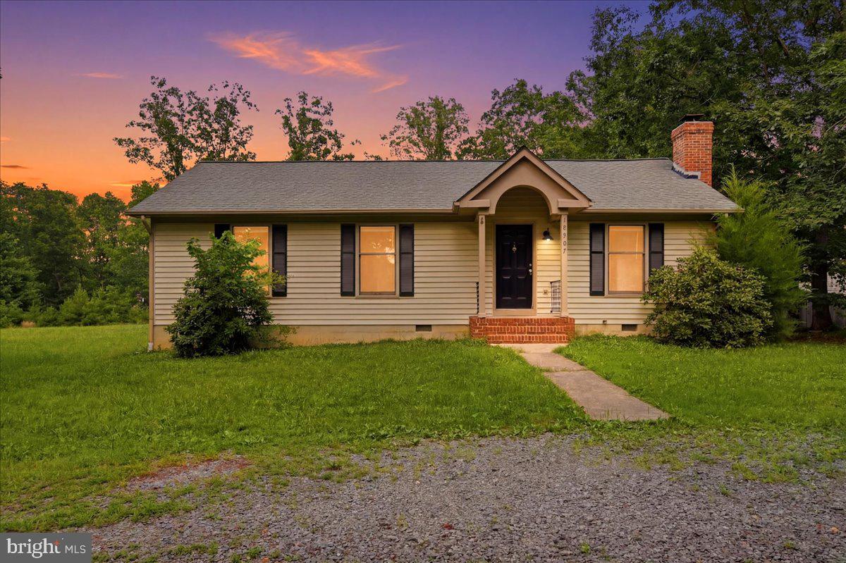 Welcome to this charming one-level home situated on a spacious half-acre corner lot in the amenity-rich Lake Wilderness community. Offering the perfect blend of peaceful surroundings and everyday convenience, this property provides comfortable living with easy access to major commuting routes, shopping, dining, and nearby services.

Inside, you'll find a thoughtfully designed floor plan featuring three bedrooms and two full bathrooms. The inviting living room is anchored by a classic brick wood-burning fireplace with a solid wood mantel, creating a warm focal point for gathering with family and friends. Wood flooring extends through the main living areas, while the bedrooms offer the comfort of carpeting. Both bathrooms have been updated with stylish tile flooring, modern vanities, and updated fixtures.

The bright, eat-in kitchen is filled with natural light thanks to its vaulted ceiling, two skylights, and sliding glass doors that lead directly to the expansive rear deck. Whether you're enjoying your morning coffee, hosting a barbecue, or simply relaxing outdoors, this space is ideal for entertaining and everyday enjoyment.

The primary suite offers a walk-in closet and a private en-suite bath, creating a comfortable retreat at the end of the day. A new septic system installed in 2020 provides added value and peace of mind.

Lake Wilderness offers an exceptional array of neighborhood amenities designed for recreation and outdoor enjoyment. Residents have access to three scenic lakes for fishing, boating, and swimming, along with a sandy beach area, community pool, clubhouse, playgrounds, picnic pavilion, tennis courts, basketball and pickleball courts, boat launches, and a variety of community events throughout the year.

This well-maintained home presents an excellent opportunity for its next owner to move in and enjoy today while adding personal touches over time. With generous outdoor space, desirable community amenities, and a convenient location, this property offers a wonderful place to call home.