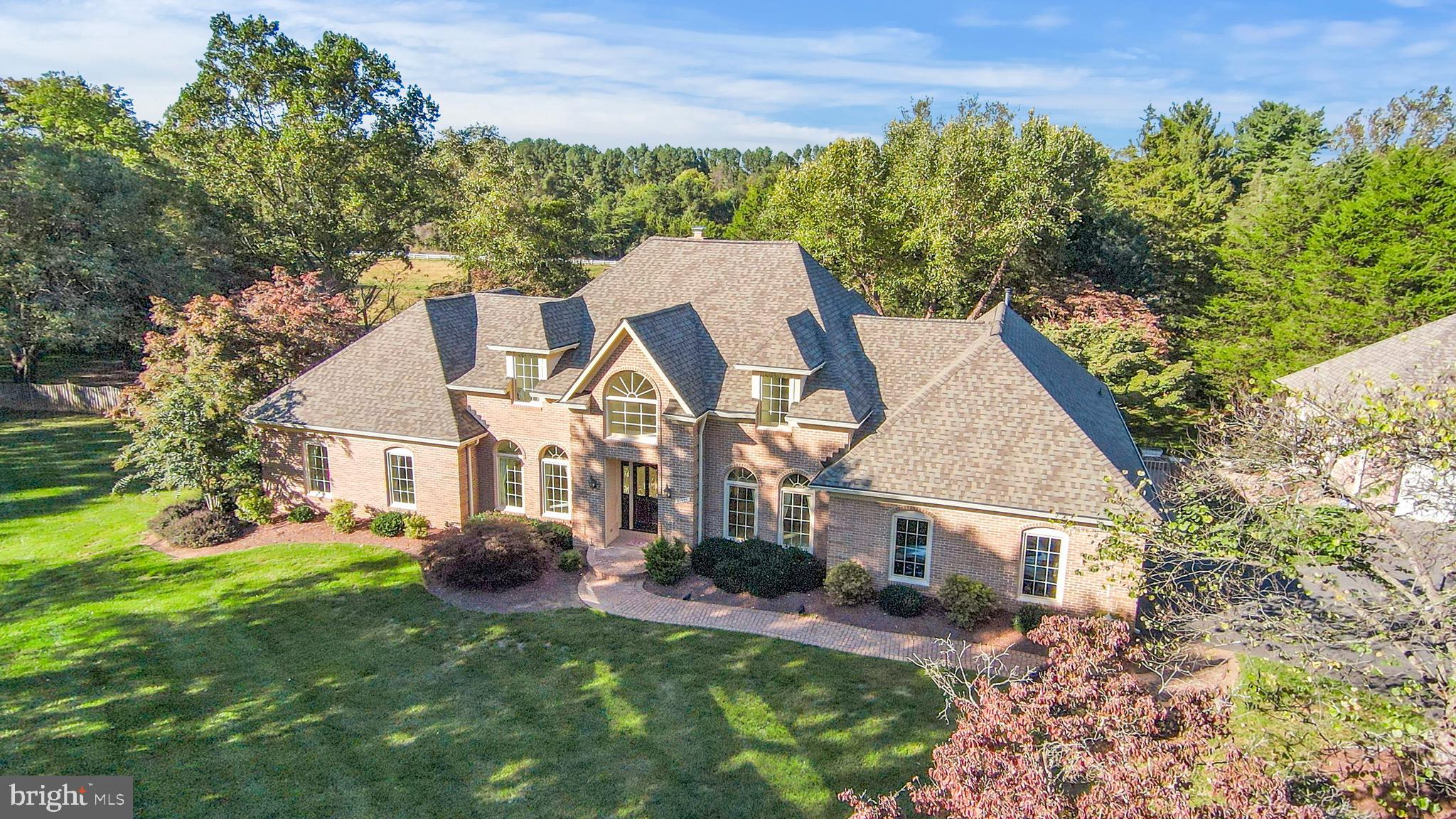 Stately Brick Colonial on a gorgeous lot in Great Falls.  Located on a quiet, no-thru street on a 1.73 acre lot, this 6400+ sq ft home offers timeless curb appeal in serene surroundings. The meticulously manicured grounds feature lush lawns, mature plantings, and cascading waterfall features that create a peaceful, picturesque setting.
What makes this home unique is that the spacious primary suite is located on the main level of the home. This private retreat has two walk-in closets, a luxurious oversized en-suite bath, a sitting area with gas fireplace and a sleeping area.  The floorplan also features formal and casual living and dining areas, a home office, powder room, mudroom and butlers pantry.  The floor plan also features multiple patios ideal for entertaining or relaxing, and a rare combination of an attached two-car garage plus a detached two-car garage—perfect for car enthusiasts or extra storage.
The lower level is a true retreat, complete with a fitness center, sauna, jacuzzi, and walk out rec room. There is a separate bedroom, bathroom and sitting room en suite with its own walk-out to a private lower patio— offering flexibility for extended stays or additional private living space.
On the top floor, two generously sized bedrooms each have their own private bathrooms. Recent updates include a newer roof and gutters (2019). The home was freshly painted in 2025, and there is new carpeting the primary suite, and new hardwoods in the living room, family room and dining room.   
The expansive kitchen, while functional, is ready for a modern transformation—custom renovation plans by a local design build firm will be available during the open houses to give the next owner a head start in creating their dream culinary space. There is  no need to add onto this home, just.  Colonial on a gorgeous lot in Great Falls.   Located on a quiet, no-thru street on a 1.73 acre lot, this custom brick colonial offers timeless curb appeal, serene surroundings, and exceptional space inside and out. The meticulously manicured grounds feature lush lawns, mature plantings, and cascading waterfall features that create a peaceful, picturesque setting.
What makes this home unique is that a spacious primary suite is located on the main level of the home. This private retreat has two walk-in closets, a luxurious oversized en-suite bath, a sitting area with a gas fireplace and a sleeping area.  The floorplan also features formal and casual living and dining areas, a home office, powder room, mudroom and butlers pantry.  Multiple patios are ideal for entertaining or relaxing, and a rare combination of an attached two-car garage plus a detached two-car garage is perfect for car enthusiasts or extra storage.
The lower level is a true retreat, complete with a fitness center, sauna, jacuzzi, and walk out rec room. There is a separate bedroom, bathroom and sitting room en suite with its own walk-out to a private lower patio— offering flexibility for extended stays or additional private living space.
On the top floor, two generously sized bedrooms each have their own private bathrooms. Recent updates include a newer roof and gutters (2019). The home was freshly painted in 2025, and there is new carpeting in the primary suite, and new hardwoods in the living room, family room and dining room.   
The expansive kitchen, while functional, is ready for a modern transformation—custom renovation plans by a local design build firm will be available during the open houses to give the next owner a head start in creating their dream culinary space. There is  no need to add onto this home, just re-imagine the existing space and customize to your liking.
This is a rare opportunity to own a distinguished home with incredible bones, beautiful views from every window, and exceptional potential—all in an idyllic Great Falls location. Schools include Forestville Elementary, Cooper Middle School and Langley High S