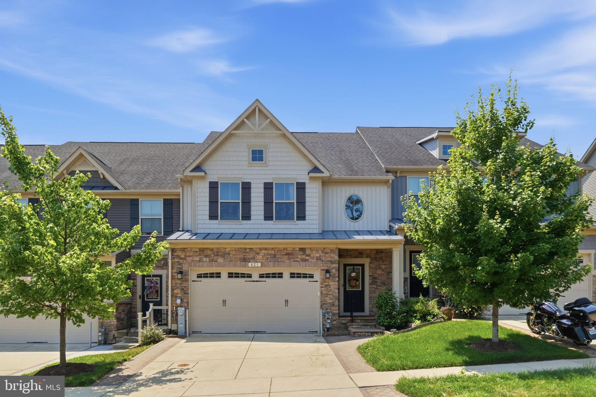 Every detail of 421 Zeman Drive has been thoughtfully designed to elevate everyday living. From the custom stone driveway banding, striking stone façade, and covered stone porch to the beautifully curated outdoor retreat, this home offers the perfect blend of comfort, style, and convenience.

Inside, the open, light-filled floor plan is enhanced by a rare four-foot extension to both the great room and the main-level primary suite, creating generous living space where you'll love to gather and unwind. Built-in speakers in the living room set the stage for effortless entertaining, while the finished basement and versatile upstairs bonus room provide endless possibilities for a home office, fitness space, media room, or guest retreat.

Step outside and discover your own backyard oasis. Backing directly to the community center for an exceptional sense of openness and convenience to amenities, the outdoor living space features a spacious deck, patio, fire pit, tranquil water feature, and fully fenced yard—perfect for everything from quiet mornings with coffee to evenings spent with family and friends.

Additional highlights include an epoxy-finished garage, Vivint smart security system, and energy-efficient solar panels for added peace of mind and long-term savings.

Perfectly located in Millersville with convenient access to Baltimore, Washington, D.C., and major commuter routes, this is more than just a beautiful home—it's the lifestyle you've been waiting for.