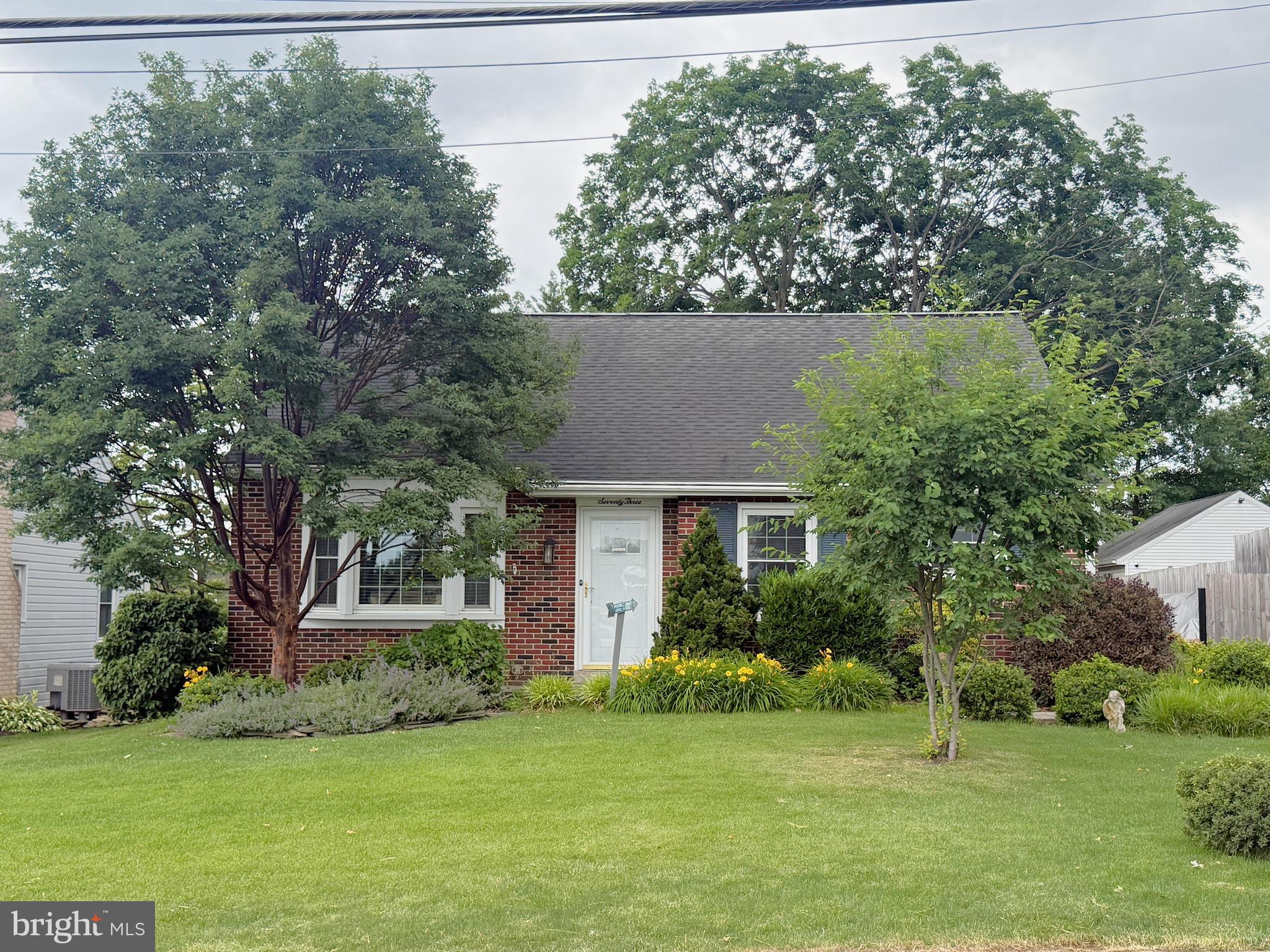 Charming 4-bedroom, 2-bath brick Cape Cod in Millersville offering over 2,400 finished square feet of living space. The main level features a spacious living room with hardwood floors and a classic wood-burning brick fireplace, along with a remodeled kitchen showcasing tile backsplash and newer stainless appliances. Completing the main level are three bedrooms with hardwood floors and an updated full bath with a walk-in tiled shower. Upstairs, the private suite offers hardwood floors, custom built-ins, skylights for abundant natural light, and a second full bath. The newly remodeled finished basement provides additional living space and includes a waterproofing system with a lifetime transferable warranty. Enjoy outdoor living from the screened porch and newer composite deck overlooking the private backyard with mature trees. A newly paved driveway leads to an electronic security gate, providing both convenience and privacy while securing the fully fenced rear yard. Additional highlights include newer efficient natural gas heat, central air conditioning, a dedicated ductless mini-split for the upper-level suite, replacement windows throughout, and an architectural shingle roof. Schedule your private showing today!