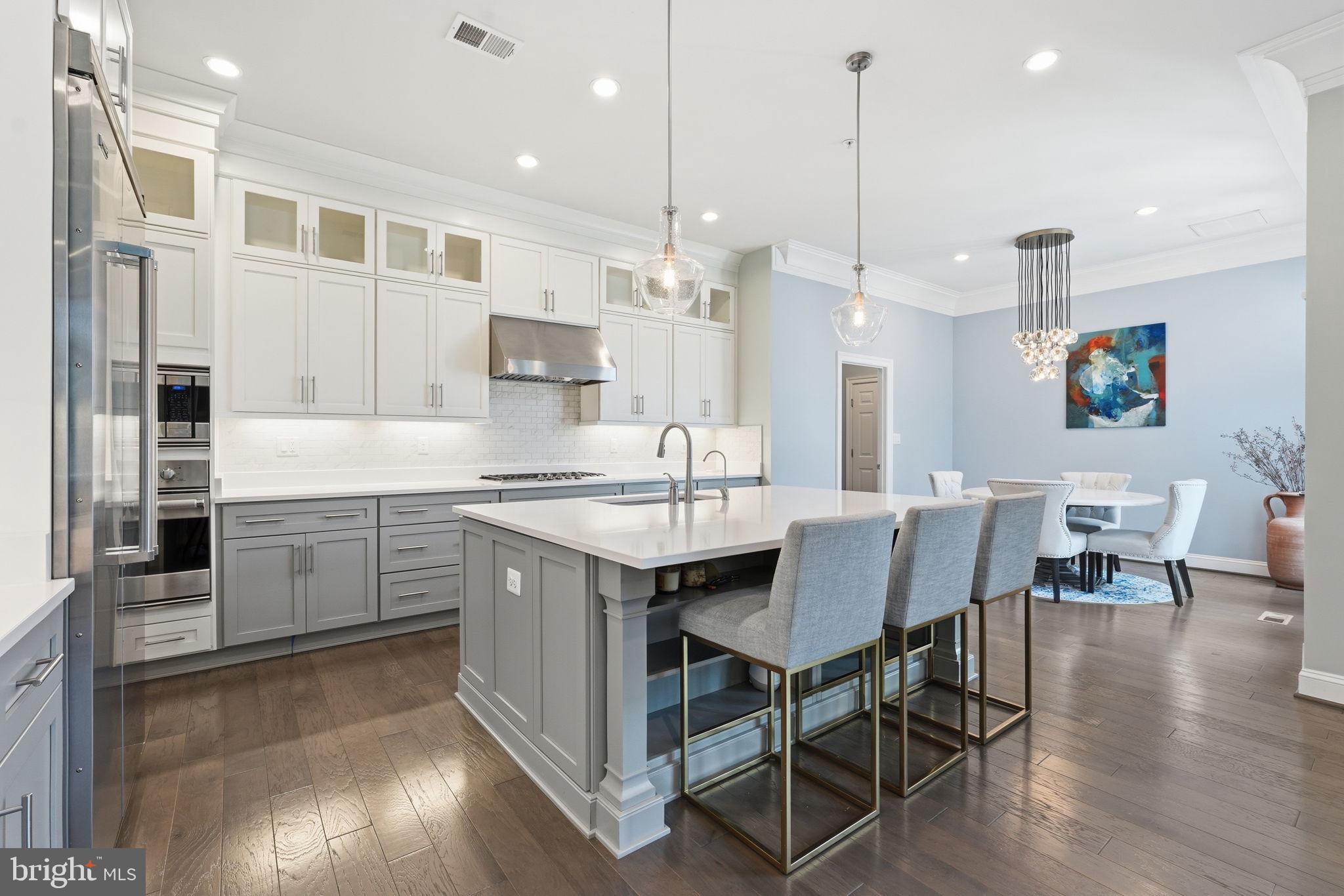 Can you imagine moving into a luxury home in the heart of Bethesda with energy efficiency that can help offset monthly utility costs? Well, now is your chance! 

Welcome to 9123 Old Georgetown Rd, one of Bethesda’s most meticulously upgraded luxury residences. Built in 2019 by Michael Harris Homes with over $200,000 in builder upgrades and further enhanced by the current owner with more than $175,000 in premium improvements, this exceptional 5-bedroom, 4 full bath, 1 half bath home offers over 5,000 square feet of thoughtfully designed living space on a desirable corner lot. Manicured landscaping, elevated curb appeal, and prominent positioning create a striking first impression. A standout feature is the fully owned Tesla solar system, valued at approximately $53,000 and conveying at no additional cost. Designed to power the home while returning excess energy to the grid, it routinely generates Pepco bill credits and may allow for near net-zero utility costs depending on usage. Inside, elevated finishes, designer lighting, and meticulous craftsmanship set the tone throughout. Restoration Hardware chandeliers anchor the main level, while oversized windows fill the home with natural light. The designer powder room features a custom accent wall with imported Spanish tile, creating a memorable statement. The chef-inspired kitchen is designed for both everyday living and entertaining, offering quartz countertops, an oversized island, professional-grade Viking stainless steel appliances, ceiling-height cabinetry, and so much more. Buyers have the full breakdown of every upgrade that was added by builder when originally built in 2019. The adjoining family room centers around a gas fireplace and overlooks the private outdoor retreat. Step outside to enjoy an upgraded deck, custom garden beds, and a tranquil fountain water feature. Upstairs, four spacious bedrooms benefit from double-insulated exterior walls for exceptional comfort and quiet. The luxurious primary suite offers dual walk-in closets, a sitting area, and a spa-inspired bath with dual vanities, a soaking tub, and oversized glass-enclosed shower. Two bedrooms share a Jack-and-Jill bath, while a fourth enjoys its own private en-suite. The fully finished lower level is ideal for entertainment and wellness, featuring a custom bar, media room, private gym, fifth bedroom, full bath, and walk-up access to the side yard.

Zoned for the highly sought-after Walter Johnson High School cluster, including North Bethesda Middle School and Wyngate Elementary, with prestigious private school options nearby. The convenience of being located just minutes from I-495 and Metro is priceless, Bethesda Mews was also strategically designed to offer a location that will forever remain in high-demand due to the proximity of many major Government Agencies and Government Contractors, including National Institute of Health (NIH), Walter Reed National Military Medical Center, Lockheed Martin, Booz Allen Hamilton, Leidos, CACI International, Food and Drug Administration (FDA), National Institute of Standards and Technology.
You’re also moments from downtown Bethesda, Wildwood Shopping Center, Pike & Rose, and other premier dining, and upscale shopping.

9123 Old Georgetown Rd offers the rare combination of luxury, efficiency, and location, an exceptional opportunity to begin your next chapter!