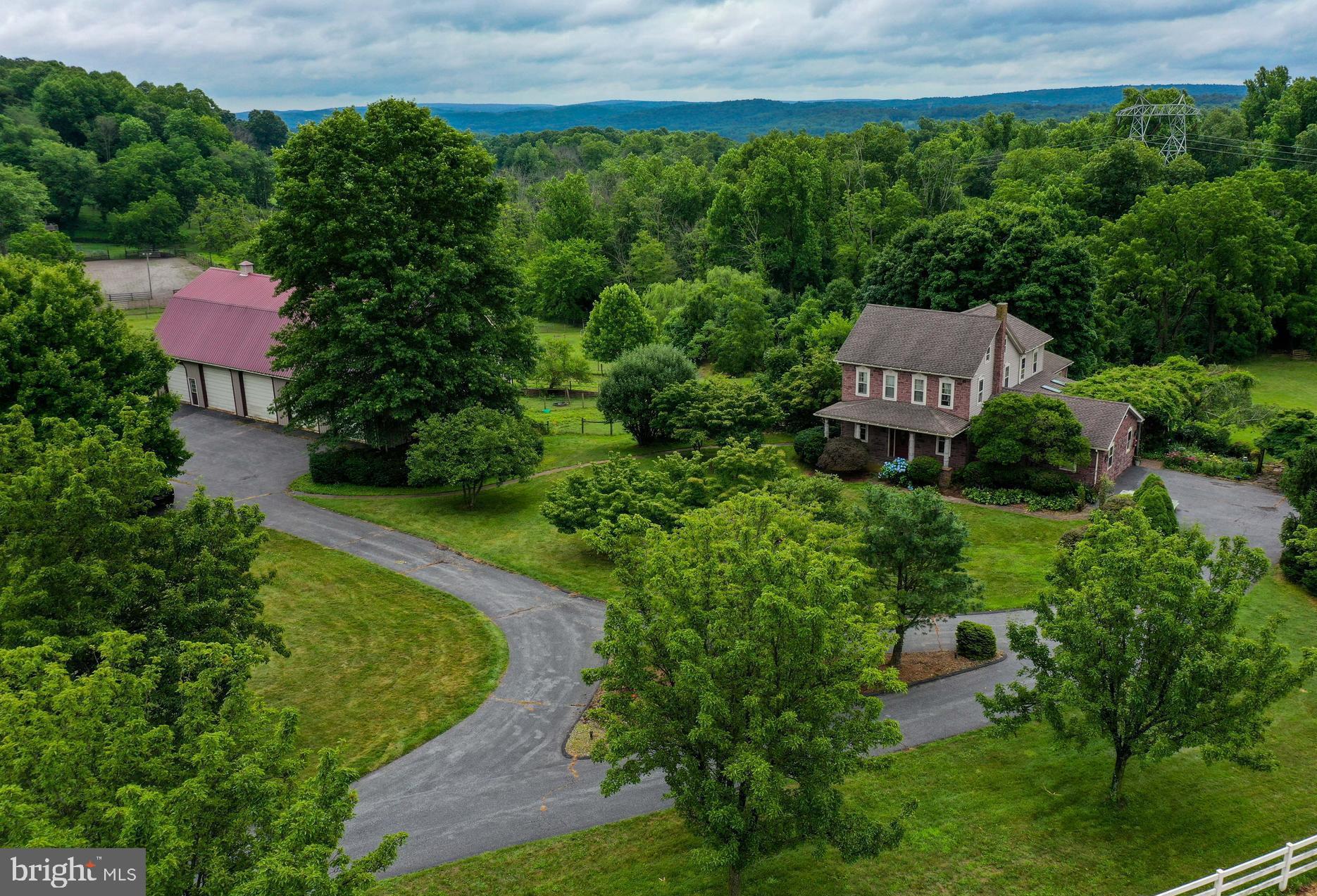 Proudly presented is a 30 acre Gentleman Farm in southern Berks County,  just over the Lancaster County line.  The tree lined driveway leads to a beautiful set of buildings that are totally surrounded by white, vinyl fence lined pastures. The sandstone farmhouse has the old time charm that is desired in a 19th century farmhouse along with all the amenities of modern living.  The home provides 3,500+/- sq.ft. of finished living space which includes 5 bedrooms & 3.5 baths. A few highlights of the home include the family room addition with a gas fireplace and huge pictures windows that provide a 180 degree view of  wood-lined pastures and the two ponds on the property; a home gym/rec room; tile flooring and a large island in the eat-in kitchen, a stone, wood burning fireplace in the living room; hardwood floors in the living room, sitting room and dining room. The 2-tier deck in the back provides excellent farmland views and is a great place for entertaining outdoors. The 42'x82' bank-barn has electric throughout and 5 large overhead doors in the upper level, providing tons of space for parking and storage. The lower level has been upgraded with cement floors and a frost-free water system,  and can be set up for horses or cattle. The carriage house provides parking for two more vehicles in close proximity to the house. The property contains approx. 19 acres of pasture/tillable acres and 9 wooded acres, with the remaining acreage for the buildings. This farm is in a great location, just minutes from Rt. 222, with nearby attractions including Nolde Forest State Park, Adamstown (antique capital of the world),  multiple golf courses, farmers stands providing fresh produce... all within 15 minutes drive.