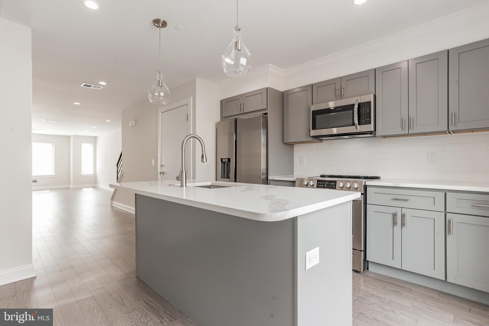 This new construction stunner built by a Premier Boutique Builder with incredible attention to detail is a must see! Live in Unit #2 of this incredible duplex located in Fishtown. Upon entering this beautiful 2 Bedroom 2 and a half bath apartment through the third floor entrance, you’ll notice a large open floor plan with lots of natural light flowing in and hardwood floors throughout. Past the living room you’ll find a powder room and linen closet which lead into the dining area and tastefully done contemporary kitchen with tons of 42 inch cabinets and self-closing drawers. The kitchen also features a large island, quartz countertops, glass backsplash and stainless steel appliances. A large glass sliding door leads you to a balcony. A custom iron railing staircase leads you to the second floor of the unit where you will find two spacious light-filled bedrooms with nice closet space, two spacious tile baths, and a laundry room. The next set of stairs leads you to the private roof deck with illuminated lighting. This unit also has access to additional storage space in the basement of the building which can be accessed from a separate entrance at the front of the building.