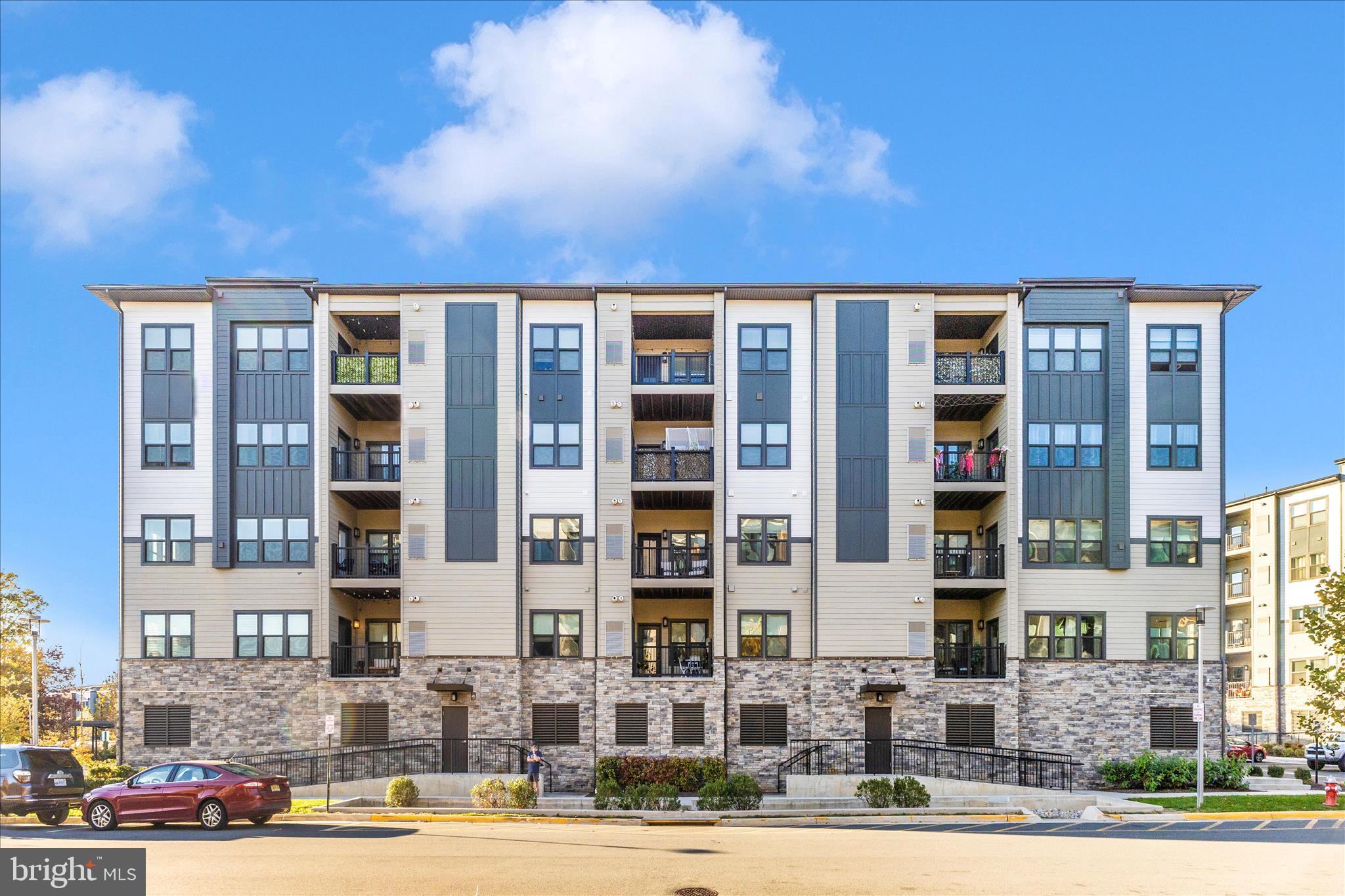 Nearly new and beautifully appointed, this two-bedroom, two-bath luxury condo —strikes the perfect balance of modern design and everyday convenience.
Walk to the Herndon Metro station and neighborhood favorites like Stone’s Cove, Kumo Sushi, and the shops at Woodland Park Crossing. Enjoy access to community walking trails, sports courts, playgrounds, and picnic areas—or head just two miles to Reston Town Center for premier dining, shopping, and nightlife.
Whether you’re a tech professional seeking a low-maintenance home near major employers, a frequent flyer craving easy Metro and Dulles Airport access, a move-down buyer desiring elevator access and walkable convenience without compromising modern style —this condo checks every box: modern, move-in ready, and minutes to everything.
