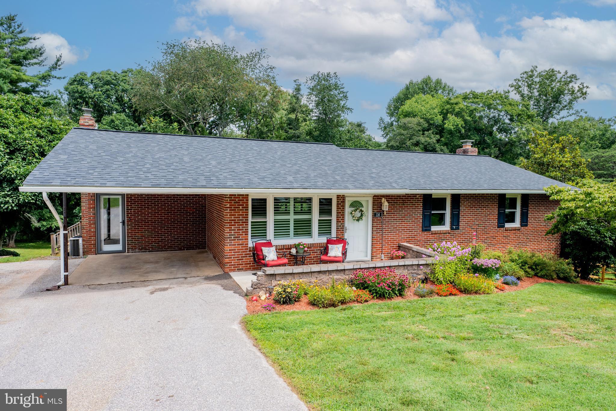 Tucked into Presidential Park, this all-brick rancher pairs easy one-level living with a finished walkout lower level that doubles the living space. The front door opens into a spacious living room that connects to the dining room — making entertaining a breeze. The large remodeled kitchen flows to a sunny breakfast nook with doors to both the front and back of the home. Luxury vinyl plank flooring runs throughout the main level. Three bedrooms and two full baths make main level living easy. Downstairs, an expansive family room with a wood burning stove and brick surround opens to a bar area and half bath, with a separate multipurpose room lined with built-in shelving — ideal for a home office, playroom, or hobby space. The walkout leads directly to a patio and the backyard. Outside, a deck and screened porch overlook a large three-quarter acre yard backing to mature trees, with an oversized 20'x10' shed and a covered carport with wide driveway parking. Lots of updates already done — kitchen, HVAC, roof, windows, hot water heater, well pump and more. All that's left is to move in.