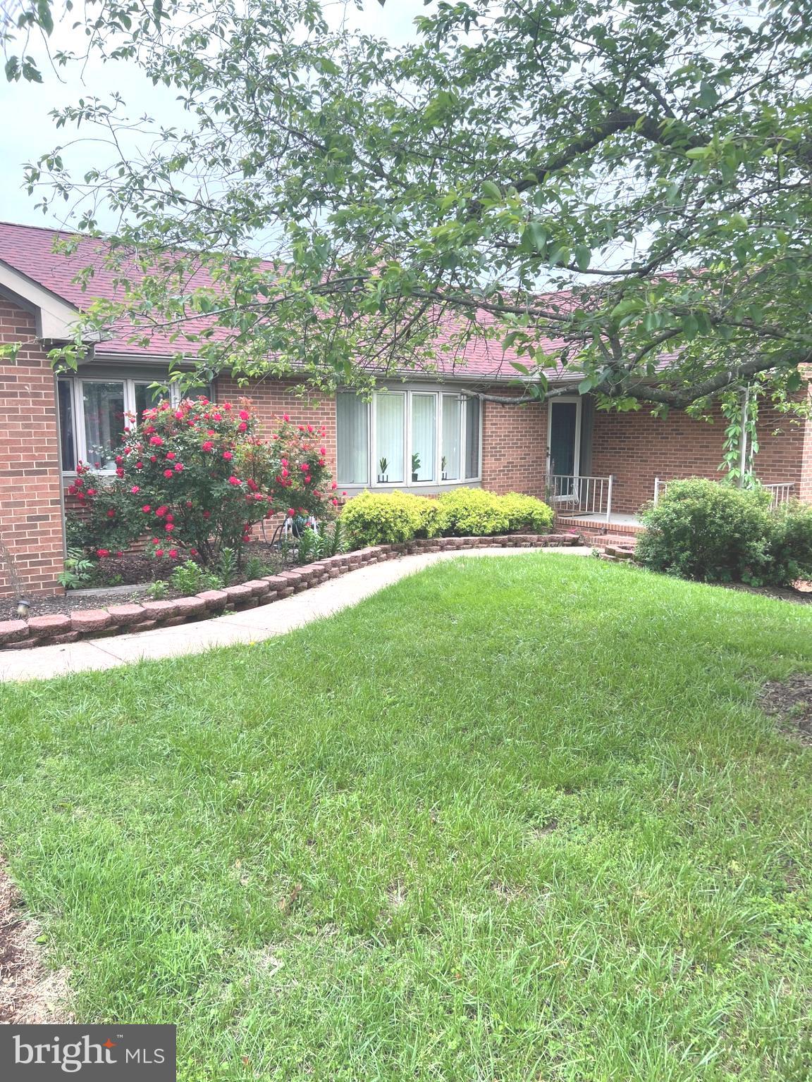 Welcome to this quiet, serene escape from the hustle bustle of everyday living that combines the convenience of main level living with a lower level, walk out basement housing an in-law suite.  This beautifully updated brick rambler is comfortable, charming and has an incredible rear deck and outdoor space.  With 1.87 acres that include mature fruit trees, this home is a private retreat with plenty of room to enjoy the great outdoors.  Inside you'll immediately notice the thoughtful updates, including renovated bathrooms with walk-in showers and multiple storage closets to keep everything organized. The full finished walk-out basement offers space for a multitude of uses —an in-law suite, a cozy hangout spot, a home gym, or even a guest suite, the possibilities are endless!  The bright sunroom is a wonderful location for a home office or play area.   The multi-level deck is perfect for hosting family and friends, and offers a place to relax, unwind, or enjoy the beautiful yard.  With all this space inside and out, plus easy access to town and major roadways, this home truly has it all. If you’ve been looking for the perfect blend of modern updates and outdoor beauty, this all brick home is calling your name!  Seller offering closing help!