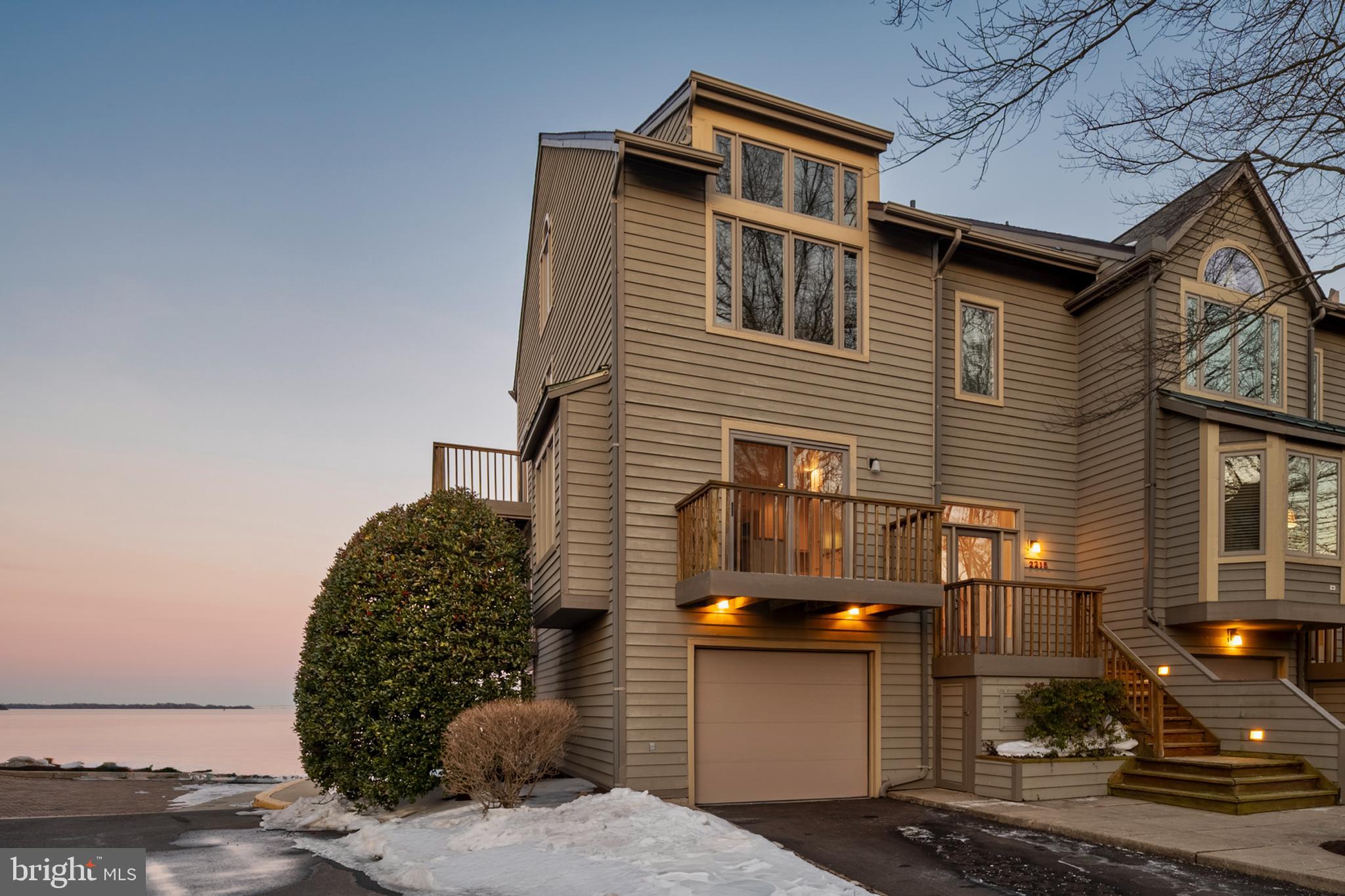 Welcome to an exceptional four level townhome in the coveted Village of Chesapeake Harbour in Annapolis, where every floor captures sweeping views of the Severn River and the iconic Chesapeake Bay Bridge. An elevator services all levels, offering both convenience and comfort while enhancing the ease of everyday living. Multiple balconies and decks invite you to step outside and take in sunrise over the water and evening lights shimmering across the Bay.

The main level showcases a generously sized kitchen with crisp white cabinetry, abundant storage, and a spacious center work area that anchors the space beautifully. The combined living and dining room is positioned to highlight the breathtaking backdrop and features its own fireplace, adding warmth and ambiance to the dramatic waterfront setting.

On the third level, the primary suite offers stunning water views, a private bath with a relaxing soaking tub, and a fireplace that creates a true retreat atmosphere. An additional bedroom with soaring ceiling and wonderful natural light, along with a hall bath featuring a tub shower combination, complete this level. The fourth floor provides exceptional flexibility as a third bedroom, guest retreat, or additional living space, all enhanced by balcony access and panoramic views.

The lower level functions beautifully as a welcoming family room with a cozy fireplace, ideal for relaxed evenings at home. From here, step directly out to the community boardwalk and pier, making waterfront walks and time by the water part of everyday life. Residents enjoy beautifully maintained common grounds, a community center, pools, tennis courts, and water privileges that define the Chesapeake Harbour lifestyle.