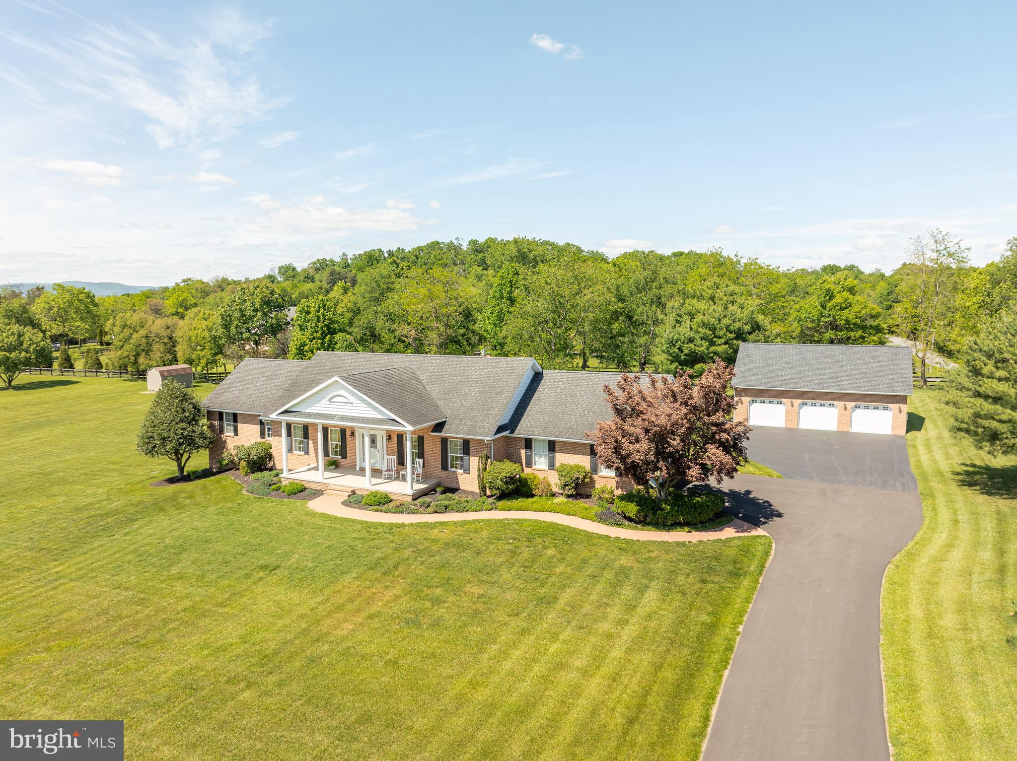 This charming brick rancher, set on a beautifully landscaped 2-acre lot, offers the perfect mix of comfort, space, and scenic views in a prime Falling Waters location. The detached 3-car garage comes equipped with a lift, air compressor, heater, and half bath. Inside, you’ll find 3 bedrooms, 2.5 baths, a cozy family room with a brick fireplace and gas insert, and a dream kitchen featuring quartz countertops, ceramic flooring, upgraded appliances, a breakfast bar, a built-in desk, and plenty of storage. The spacious primary suite boasts a bath with separate shower and jetted tub, a large walk-in closet, and direct access to the multi-level deck. A full walk-out basement offers excellent storage and can easily be finished to double the living space. This custom-built home is in immaculate condition and move-in ready! Open house: Sunday, June 14 from 1–4 PM.