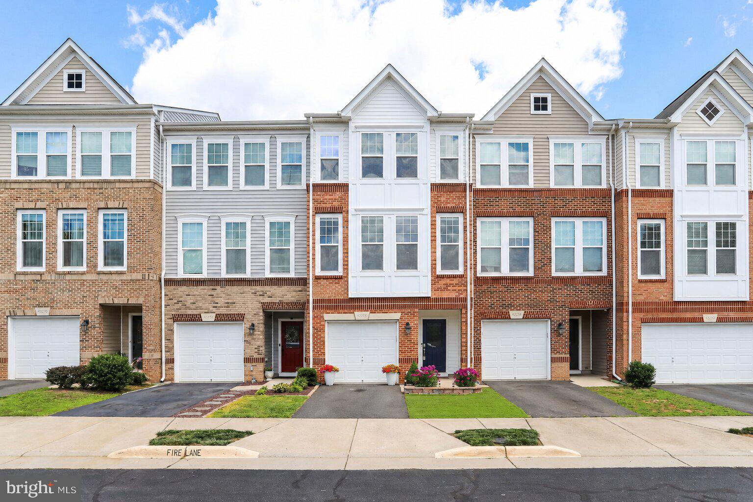 Come check out this townhome featuring a desirable open concept floor plan and numerous upgrades throughout. The upscale kitchen boasts a spacious center island, granite countertops, and stainless steel appliances, making it perfect for entertaining and everyday living. Enjoy hardwood floors throughout the entire main level and durable luxury vinyl plank flooring on the lower level. The family room flows seamlessly into the kitchen and dining area and all offer easy access to the deck overlooking trees, providing a peaceful outdoor retreat. Additional highlights include an upgraded washer and dryer, ample parking with additional spaces conveniently located across the street, and a well maintained interior and exterior that shows pride of ownership throughout.  Ideally situated in a prime commuter location with quick access to the Metro, airport, major routes, shopping, dining, and community amenities. Location, location, location—this exceptional townhome combines comfort, convenience, and style in one outstanding package.