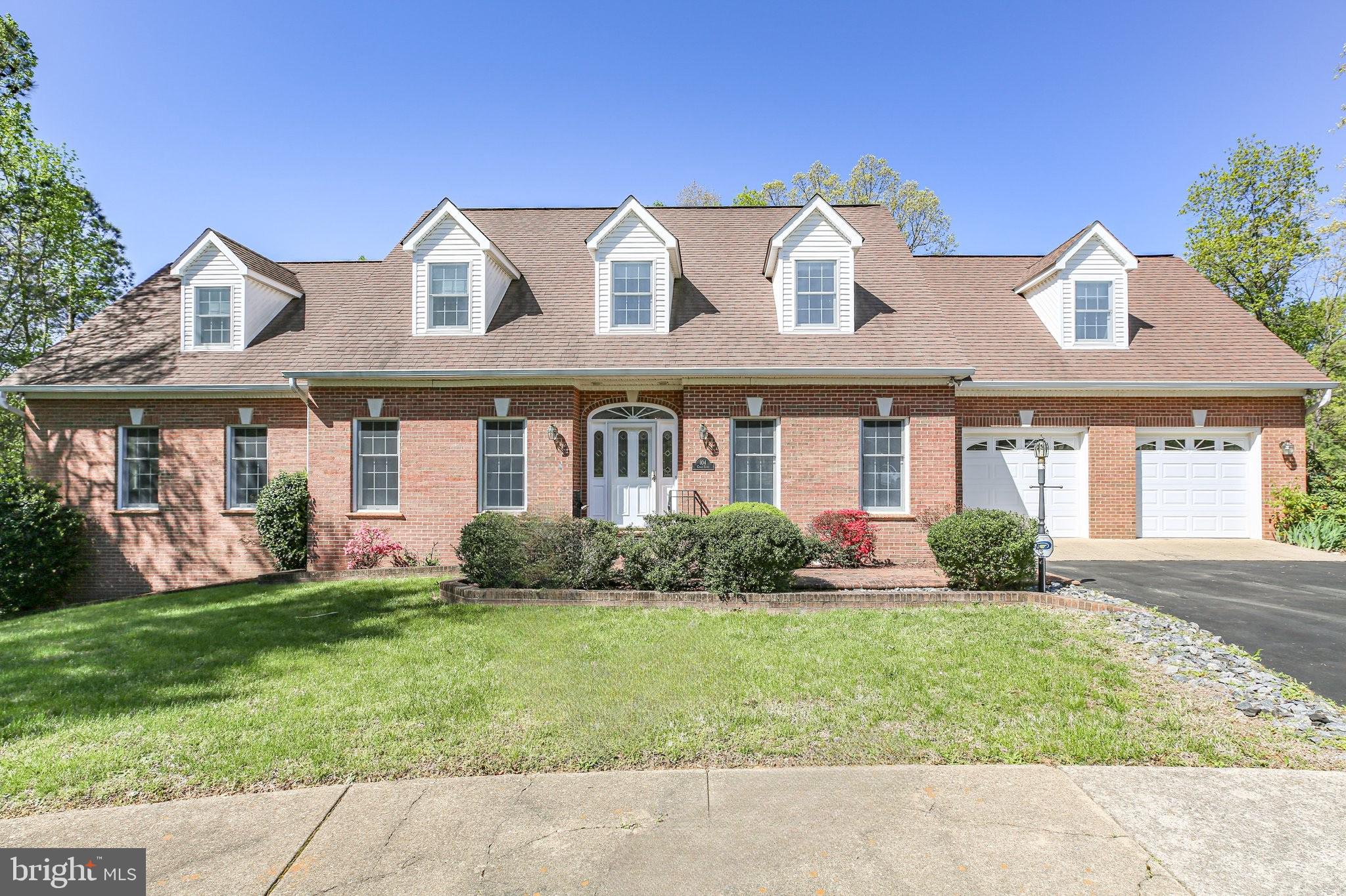 Welcome to your dream home in the desirable neighborhood of Huntington Hills ready for a large family or multi-family with two separate living spaces, each with their own kitchens, living space and 2-car garage. This 5 Bedroom, 4 (full bath), 2(1/2 bath) 3,602 sq ft (above grade), and 1,853 (below Grade) brick, custom home is nestled on a 0.51 Acre cul-de-sac lot and features a finished basement, main level primary bedroom, 3 additional bedrooms with ensuite bathrooms, (2) kitchens and (2) 2-car garages and 2 bonus rooms. As you enter through the elegant foyer, you are greeted by beautiful hardwood flooring that span throughout the home leading you into the formal living room and formal dining room adorned with chair railing and crown molding. The seamless flow from the elegant dining room to kitchen makes hosting intimate dinner parties a breeze. The kitchen features tile flooring, wooden cabinetry, laminate countertops, white GE Refrigerator, double oven, cooktop, and dishwasher. The kitchen island provides extra cabinet storage for small appliances and gives ample space for prepping meals. The extended countertops allow you to easily add bar stools for additional seating. The kitchen provides room for hosting a breakfast table, perfect for enjoying your morning cup of coffee overlooking the lush, fenced yard and covered deck. The Butler pantry features wooden cabinetry, laminate counter tops, GE standing freezer and provides a plethora of storage and space for serving meals. The Butler Pantry leads to the main level 2-car garage and laundry room with Armana washer and dryer set. The living room includes a stunning brick mantel fireplace (gas logs) and built-in bookshelves that add a touch of sophistication in addition to the second access to the covered deck. A half bathroom is conveniently located in the foyer hall for Guest. Completing the main level is the expansive Primary bedroom with walk-in closet, ensuite bathroom featuring tile flooring, linen closet, dual vanity, shower/bath combo and stand-up shower with glass door. Make your way upstairs to discover the second floor which boasts two generously sized bedrooms, each offering ample closet space and natural light. The bonus room is versatile and can be used as a home office, playroom, or guest suite. Two full bathrooms provide convenience and luxury for residents and visitors alike and feature tile flooring, vanities, and shower/bath combo. The beautifully finished basement can easily transform into a separate apartment, perfect for guests or additional rental income. The basement includes 1 bedroom with ensuite bathroom (full), ½ bathroom, second kitchen, second laundry room, brick wood burning fireplace and mantel, built in bookshelves, built in storage, wet bar, pool table, living area, and separate 2-car garage with wood shelving and workspace. The second kitchen includes wooden cabinetry, laminate countertops, GE electric cooktop, GE single wall oven and GE refrigerator with icemaker. Walk-out to the expansive brick patio and enjoy the lush foliage surrounding the wooden privacy fence. Whether you're hosting a summer BBQ or enjoying a quiet evening under the stars, this backyard oasis has it all. Residents and Guest will enjoy the convenience of the asphalt driveway which allows access to the main level garage and leads to the second garage creating separate entrances for both living spaces. Located just minutes from Downtown Fredericksburg, VRE, hospital, shopping and local parks. This home truly has is all!  Don't miss out on this opportunity to make this lovely house your forever home! Schedule a showing today and experience all that it has to offer.