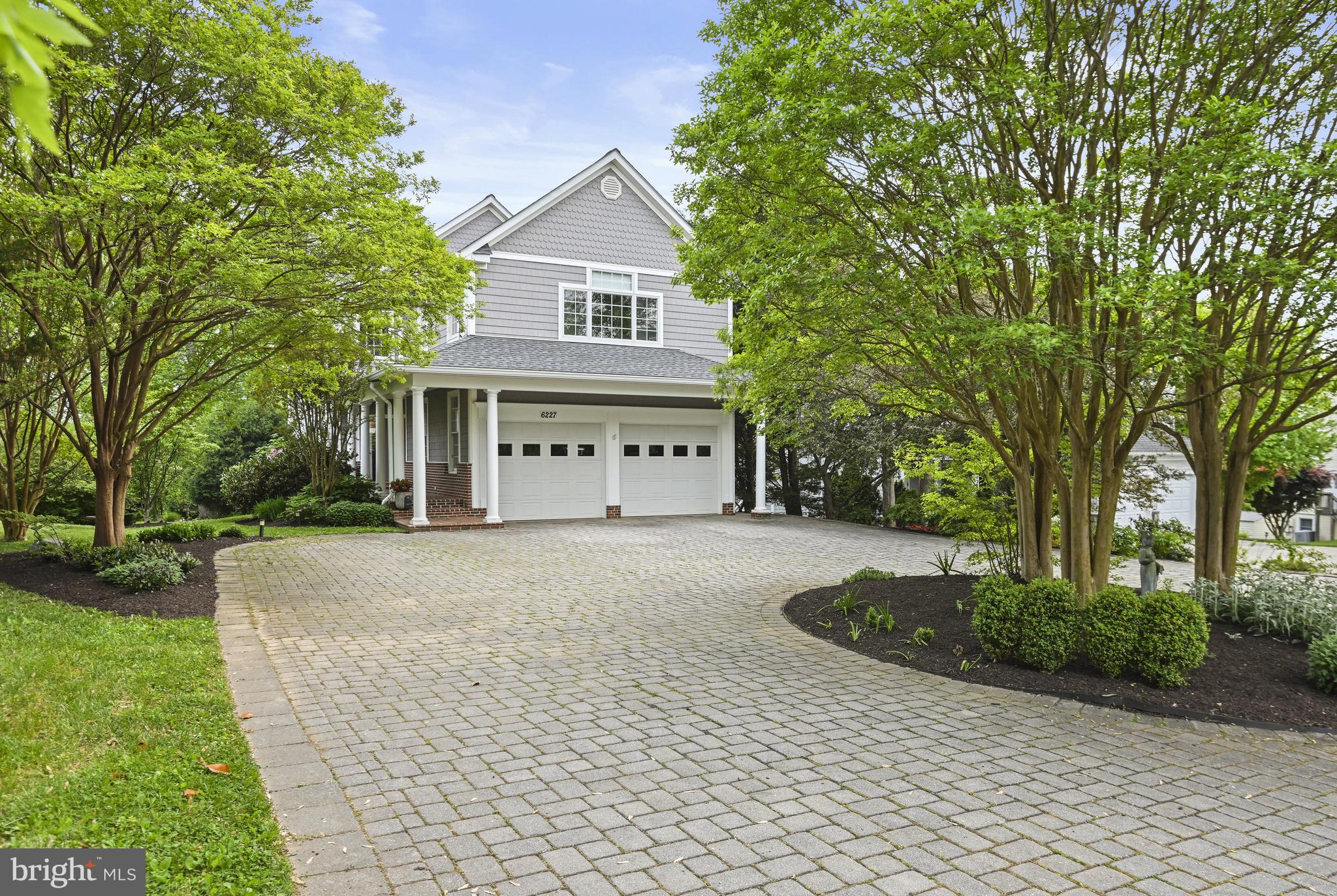 Welcome to 6227 Cottonwood Street, a beautiful Nantucket-style custom-built home by Curtis-Jacoby Builders, conveniently located in McLean, VA.  Built in 2000, the home boasts 5 Bedrooms, 4.5 Bathrooms, 2 gas fireplaces, and an oversized 2 ½ car garage.  Enter from the inviting brick front porch and you will find a bright and airy entryway with modern staircase and palladian two-story windows.  The main level features spacious Living and Dining Rooms with crown molding and large bay windows with ample natural light.  The Family Room boasts a cozy gas fireplace with granite surround and access to the deck, perfect for entertaining guests or relaxing at home.  Cooking enthusiasts will delight in the gourmet Kitchen, complete with granite countertops, custom cabinetry, and high-end stainless steel appliances. There is a bar area with seating as well as informal dining space which provides a sunny retreat with bay window overlooking the lush landscape.  Upstairs, the Primary Bedroom Suite is a private oasis with a tray ceiling, morning bar, two walk-in closets with built-in shelves and lighting. The luxurious ensuite Bathroom complete with a soaking tub, free-standing shower, and vanity with dual sinks was renovated in 2021.
There are three additional bedrooms on this floor.  One Bedroom is large enough for a sitting area and has an ensuite Bathroom and large walk-in closet. The other two bedrooms share the third Bathroom on this level.  A bright and cheery, windowed laundry room equipped with Samsung front-loading appliances completes the upper level.  The daylight and walk out lower level offers flexible living space with a Recreation Room, Kitchenette, fifth Bedroom, and Full Bathroom.  The space is ideal for guests or multigenerational living.   Outdoor lifestyle at its best includes expansive deck, brick paver patio off the lower level, and landscaped yard, all of which provide the perfect backdrop for recreation and relaxation. Sited on a generous ½ acre deep lot with western park vistas.  Located in the highly desirable Fairfax County school pyramid of Chesterbrook Elementary, Longfellow Middle and McLean High School.  The bus stop for all three schools are located at the intersection of Cottonwood Street and Kirby Road.
Conveniently located near parks, shopping centers, and major commuter routes, this home offers the perfect blend of luxury, comfort, and convenience.  This is your opportunity to make 6227 Cottonwood Street your home.  Schedule a showing today!