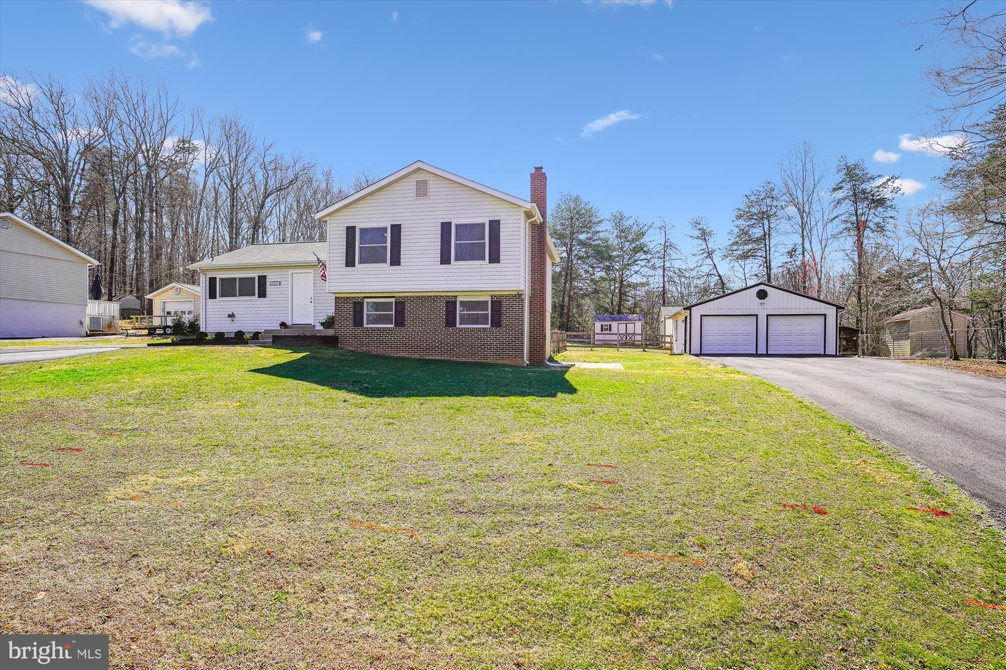 Country living with city convenience is found in this neighborhood with NO  HOA  . Public water, Public Sewer!  Great location off Hoadly Rd between Prince William Parkway  and  Rt #234 .  WOODBRIDGE AREA Convenient to I95, This 4 level split home is situated on .48 Acre level lot backing to trees and features a Detached 2 car garage with work shop area  and the updated  with 2 Smart Garage door openers that can connect to cell phone. A beautifully renovated home. The main level with an Open Floor Plan features cathedral ceiling, hardwood floors throughout main level, the foyer with stairs with decorative rails leads to upper and lower levels. Upgrades and Additions through-out make this home ready to move right in. Main level features Updated Kitchen Feb. 2025 new cabinets, granite counters, Mosaics Carrera backsplash tile, Dining area with walk-out to stamped concrete patio and a Great Room for family gatherings. The Upper Level features Primary bedroom suite with Luxury Bath featuring updated walk-in shower with designer tile rain shower and handheld fixtures, vinyl plank flooring and vanity; additional 2 bedrooms and 2nd updated bath with designer tile and tub/shower, vinyl plank flooring. Lower 3rd Level features large rec room with media area, vinyl plank floor, wood stove sitting on brick base, with brick wall and added brick wood box, and a walk-out to side yard and 2 car garage, powder room, and utility room. 4th level features large unfinished space with washer/dryer area .
So MANY MORE UPGRADES:    PEX PIPING THROUGH-OUT, THOMPSON CREEK WINDOWS  2023 AND THOMPSON CREEK DOORS  2025, HVAC RUN TRU SYSTEM 2023, 2 DRIVEWAYS, WIRED FOR INTERNET THROUGH-OUT SEE INFO SHEET, UPDATED LIGHT FIXTURES, 4 CEILING FANS, BLACK HARDWARE AND HINGES IN MOST AREAS. Great location for commuters, convenient to all schools, shopping, etc.
Be sure to see the list of upgrades and additions in BRIGHT DOCS>