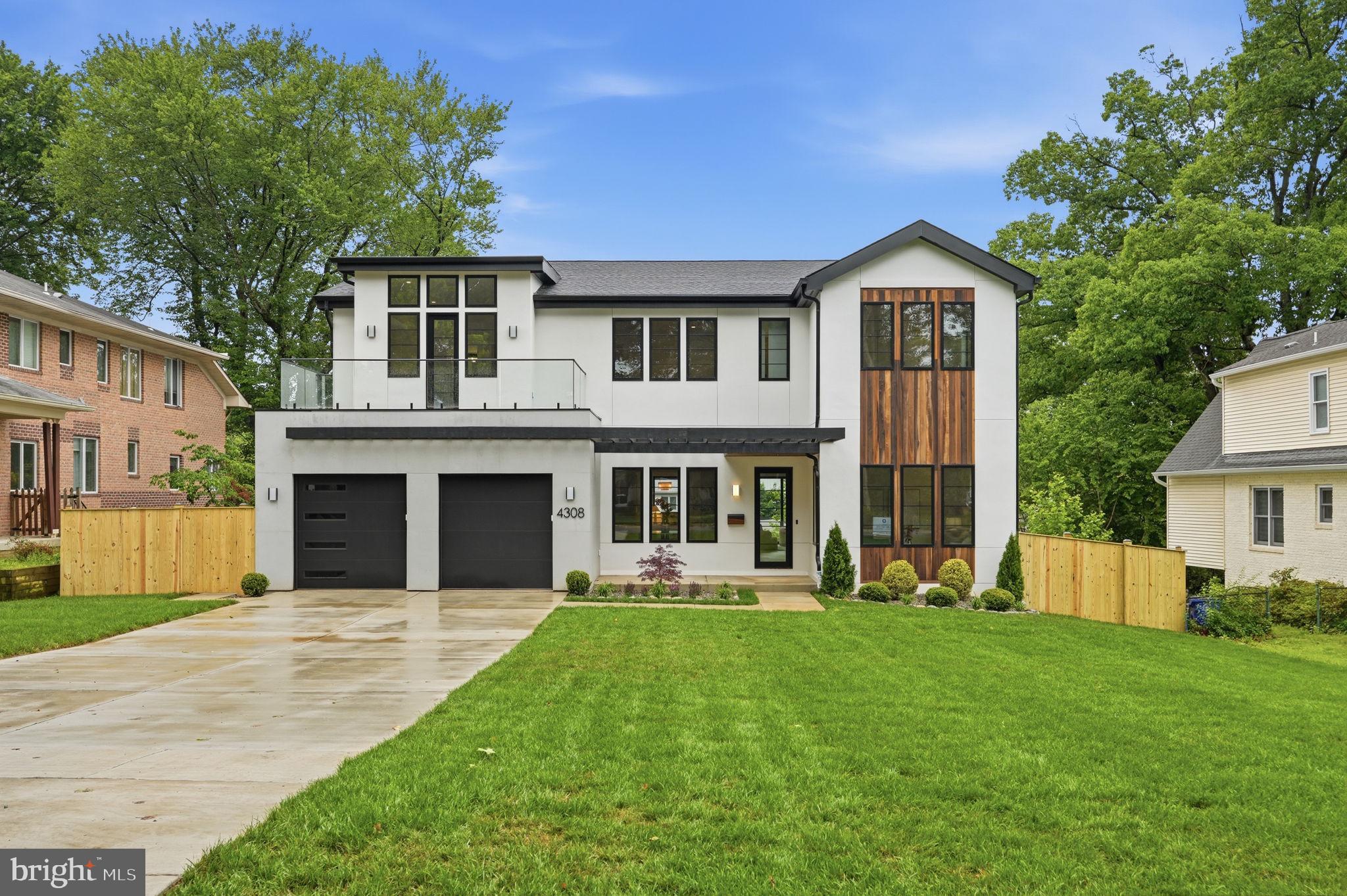 Welcome to 4308 Dresden Street, a remarkable new construction residence in the heart of Chevy Chase View’s coveted Martin’s Addition. Thoughtfully designed and expertly built by Colonial Design & Build, this one-of-a-kind transitional home blends refined modern architecture with the warmth and livability of timeless design.
Set on nearly a quarter acre and offering over 6,400 square feet of finished living space, the home showcases a striking exterior composition of stucco, concrete cladding, wood, glass, and Hardie plank siding—creating a sophisticated presence that feels both bold and enduring. Inside, expansive windows, soaring 10-foot ceilings, and thoughtfully curated finishes fill the home with natural light and understated elegance throughout.
A gracious foyer opens to formal living and dining spaces, highlighted by white oak ceiling beams, designer lighting, and architectural details that create an immediate sense of warmth and refinement. At the center of the home, the chef’s kitchen features custom white and white oak cabinetry, Ivory Taj quartz surfaces, brushed brass hardware, a full Thermador appliance suite, and an oversized island designed for both everyday living and effortless entertaining. A separate prep kitchen and butler’s pantry—with additional cooking appliances, dishwasher, and sink—adds exceptional functionality for hosting on any scale.
The family room is both inviting and sophisticated, anchored by a cast-stone fireplace, custom arched built-ins, and expansive sliding doors that open to a partially covered terrace with dedicated grilling space and elevated neighborhood views. A private home office, discreetly positioned powder room, and thoughtfully designed mudroom complete the main level.
Upstairs, the home offers five bedrooms, four bathrooms, two glass balconies, and a spacious laundry room. The primary suite serves as a private retreat, featuring 12-foot ceilings, a secluded balcony, custom white oak closets, a sitting room with fireplace and built-ins, and a spa-inspired bath with dual rain showers, soaking tub, and curated designer finishes.
The walkout lower level continues the home’s elevated aesthetic with nine-foot ceilings, hardwood flooring, abundant natural light, a custom media wall, wet bar with wine and beverage storage, home gym, guest suite, and generous entertaining spaces designed for both relaxed evenings and large gatherings alike.
4308 Dresden Street is a rare offering—an architecturally distinctive residence crafted with intention, sophistication, and an exceptional attention to detail. For buyers seeking something beyond the expected, this home delivers a truly unforgettable living experience.
