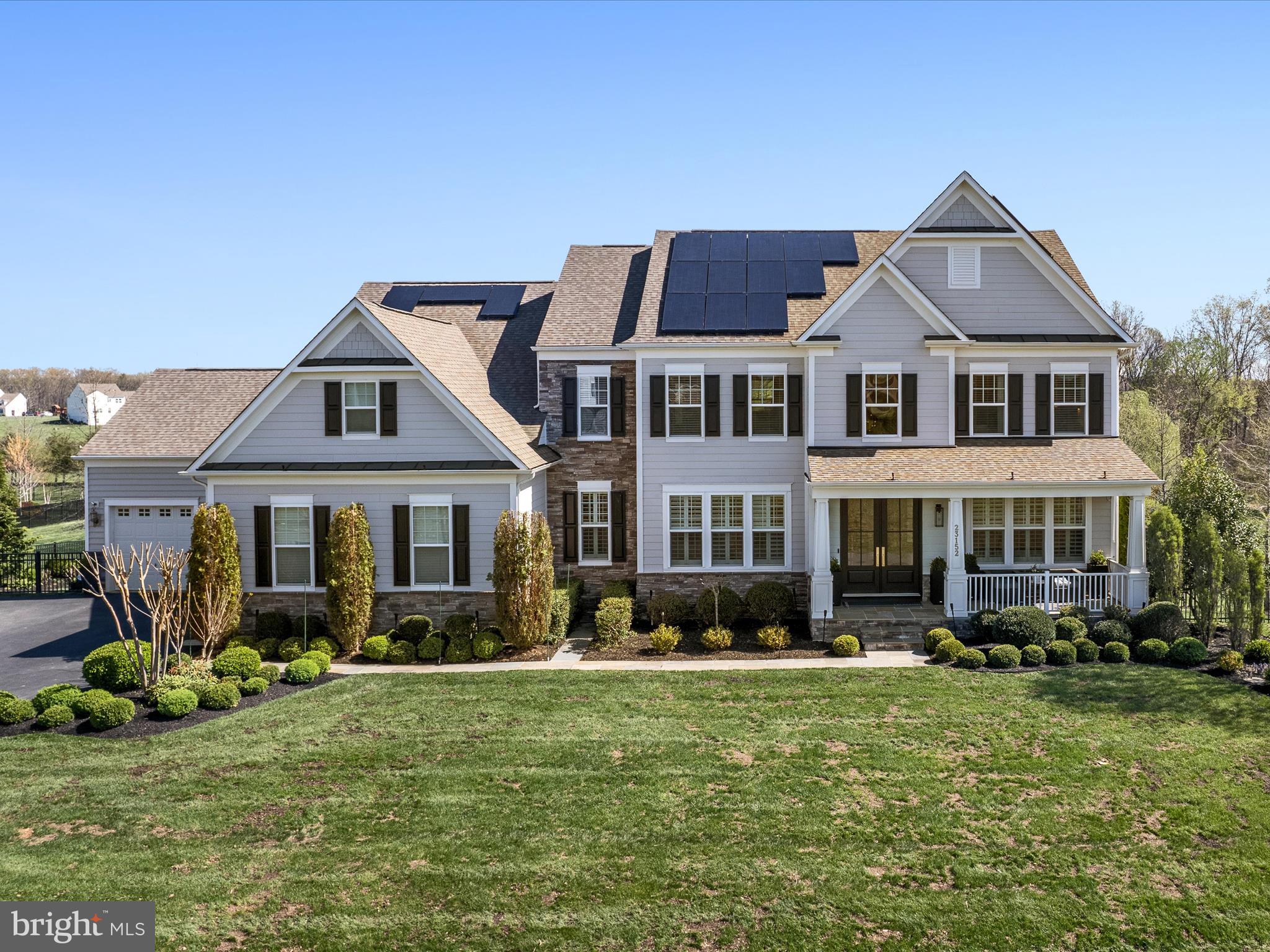 Stunning Mid-Century Modern with Asian Influence – Over $800K in Custom Upgrades!
Welcome to 23152 Kingwood Forest Ct, located in the sought-after community of Huntleigh in Creighton Farms. This exceptional 5-bedroom, 5.5-bath home offers over 7,000 sq. ft. of modern luxury on a beautifully landscaped 1.81-acre lot. Blending architectural elegance with designer finishes, this home features over $800,000 in custom upgrades.
The main level showcases a grand entry with custom double front doors, motorized shade, plantation shutters, custom light fixtures, a striking feature slat wall, and engineered hardwood floors throughout. The family room includes a see-through fireplace and French doors leading to a private library/home office. Recessed lighting, upgraded floor registers, and nickel switch plates add to the refined detail.
The gourmet kitchen boasts a brand-new Wolf cooktop, microwave, two dishwashers, granite countertops, and a fully customized pantry with appliance lifts, integrated outlets, and under-cabinet lighting. The powder room is stylishly updated with a floating quartzite vanity.
Upstairs, the primary suite offers tray ceilings and a spa-like bath with Schluter heated marble floors, premium Kohler fixtures, a quartz soaking tub, walk-in wet room shower, pocket door water closet, bespoke cabinetry with integrated plug-ins, and motorized blinds. Two additional full baths also feature heated floors and pocket doors. The laundry room includes a new washer, updated cabinetry, and a pocket door.
The finished basement includes a fully plumbed custom bar with quartzite countertops, walnut butcher block work surfaces, beer fridge, beverage refrigerators, ice maker, dishwasher, and built-in speaker system. A wine room with custom shelving and lighting sits just behind the bar. Additional lower-level spaces include a media room with tray ceiling and mural, a large recreation room, a bedroom, full bath, and a spacious office—perfect for guests or remote work.
The staircase features upgraded hardwood treads and a luxurious wool stair runner. The library on the main level includes recessed lighting, custom shelving, and luxury vinyl flooring.
The 4-car garage includes EV charging, a cold block door between bays, and a spigot. The home is equipped with solar panels and a whole-house generator. Additional systems include a new submersible well pump (2023) and new furnace (2024).
Outdoor living is a true retreat. Enjoy a Trex deck with a waterproof ceiling over the covered patio, ceiling fans, and recessed lighting. Over 2,500 sq. ft. of flagstone patio features a gas fire pit, stone seating walls, a decorative plinth, and advanced drainage. A paved walkway leads to a garden spigot, and additional spigots are located at each corner of the home. The front yard drainage culvert is lined with river stone.
The outdoor kitchen includes Blaze appliances—a 6-burner grill, griddle, two flame bars, drink cooler, stainless steel drawers, and garbage drawer—topped with a granite waterfall countertop and fully connected to gas and electric.
Exterior systems include an 18-zone app-controlled irrigation system and garden/architectural lighting with front and back zones. The yard is enclosed with powder coated aluminum rear fencing and an invisible fence system covering both front and back.
This one-of-a-kind property offers a perfect blend of design, comfort, and smart features in one of Northern Virginia’s premier communities. Don’t miss the opportunity to experience this architectural masterpiece.