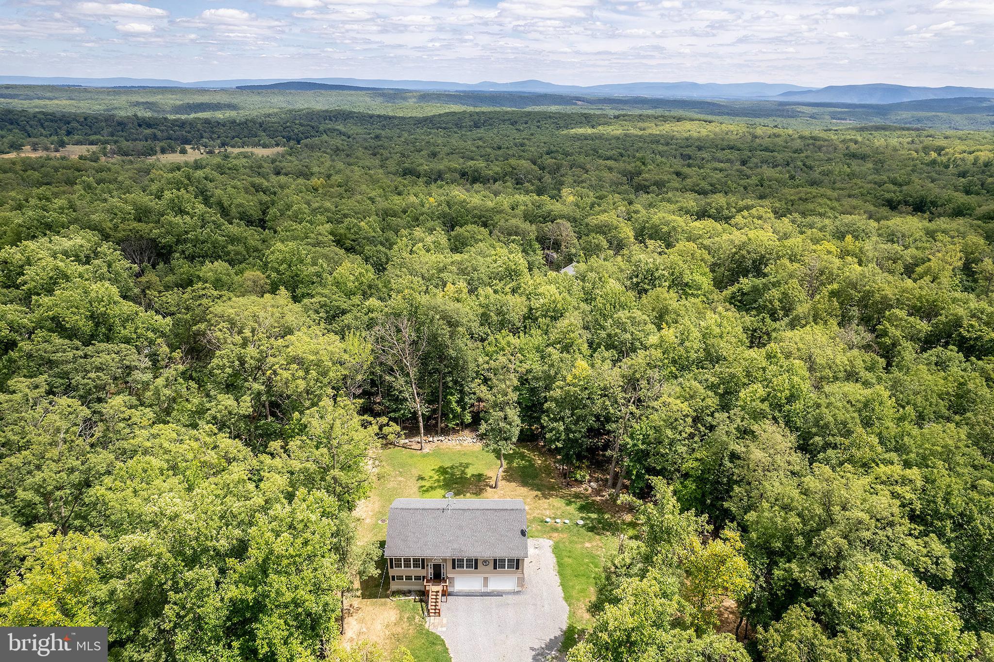 Nestled on a spacious .52-acre lot in the  Wilde Acres community, this inviting 3-bedroom, 2-bath split foyer home offers 1,820 square ft of living space. 
Water softener 2015, septic pumped & inspected 2023 & maintained annually, sump pump, new dishwasher 2024, new LVP flooring. The seller uses Winchester Wireless. 
The home has new luxury vinyl plank flooring, enhancing its modern appeal. The main level features a well-appointed kitchen equipped with stainless steel appliances, a functional island, and a pantry for ample storage. The bright and airy living areas provide a warm and welcoming atmosphere. An unfinished basement with rough-in bath plumbing presents an opportunity to customize additional living space to suit your needs. The oversized 2-car garage provides plenty of room for vehicles and storage. The attic also offers extra storage space, ensuring that everything has its place. Enjoy the community's amenities, including a common area, lake, picnic area, playground, and more, making this home a perfect blend of tranquility and activity. Ideal for those seeking a serene lifestyle with modern conveniences, this home is ready to welcome you.
