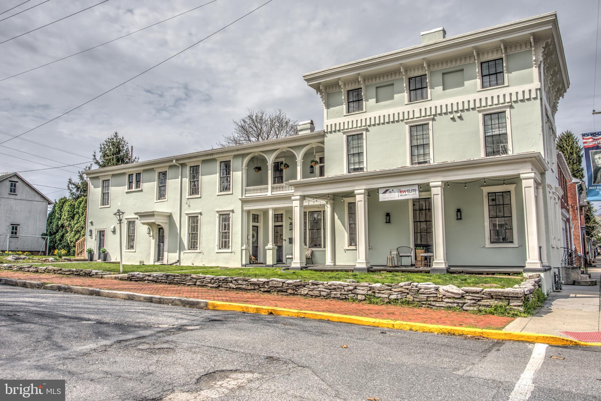 Class A Mixed Use Gem in Mount Joy's Central Business District

Welcome to a historic treasure that seamlessly blends the past with the present in the heart of Mount Joy's Central Business District. This meticulously renovated mixed-use building, dating back to 1864, stands as a testament to Italianate architecture and the rich heritage of the community. Fully revitalized from 2019 to 2021, this property offers a harmonious fusion of classic charm and contemporary convenience, making it an enticing prospect for both investors and discerning occupants.

Property Highlights:

Prime Location: Nestled within the bustling Central Business District, this property enjoys a vibrant atmosphere, surrounded by local shops, restaurants, and amenities, ensuring high foot traffic and visibility.

Historic Elegance: Restored soft pine hardwood floors and high ceilings serve as a backdrop to the building's storied past, celebrating the legacy that this landmark has woven into Mount Joy's fabric for over a century.

Versatile Office Space: The first floor boasts a professionally designed office space spanning 1,100 square feet. The open and airy floor plan creates an inviting environment for business endeavors. A modern kitchen/break room and ADA-compliant bathroom enhance functionality.

Luxurious Residential Retreat: Ascend to the second and third floors, where a high-end residential haven awaits. The 4 bed/3 bath living space spans 2,200 square feet. This space exudes warmth and sophistication. A welcoming entry at both front and back entrances provides convenience and flexibility.

Architectural Marvel: An exquisite glass-enclosed back staircase has been added, enhancing both aesthetics and accessibility while complementing the building's historic charm.

Gourmet Kitchen: The residential kitchen seamlessly marries modern finishes with the allure of exposed brick, creating an ambiance that's both contemporary and timeless. Ample storage and workspace cater to culinary enthusiasts.

Masterful Design: The main level of the residential space showcases a primary bedroom with a massive walk-in closet, offering comfort and convenience. The kitchen, hall bathroom, dining room, and living room create a seamless flow for daily living and entertainment.

Private Quarters: The top floor of the residential space houses two additional bedrooms each with their own ductless mini-split system for maintaining privacy and functionality.

In-Law Suite or Guest Haven: Discover a separate, inviting space behind the kitchen, ideal for a private office space, in-laws, a nanny, or overnight guests. Complete with a cozy living room, bedroom, and full bathroom, this space enjoys its own exterior entrance.

Historic Barn Conversion: The barn, transformed into a 2-car garage years ago, offers a unique touch to the property's character. Ample storage on the upper level of the barn ensures organization and convenience.

Whether you're an investor seeking a prized property with multiple income streams or an individual looking to immerse yourself in the dynamic Mount Joy community while indulging in the finest in modern living, this mixed-use gem provides an unmatched opportunity. Discover the perfect blend of history, elegance, and modernity – schedule your showing today.