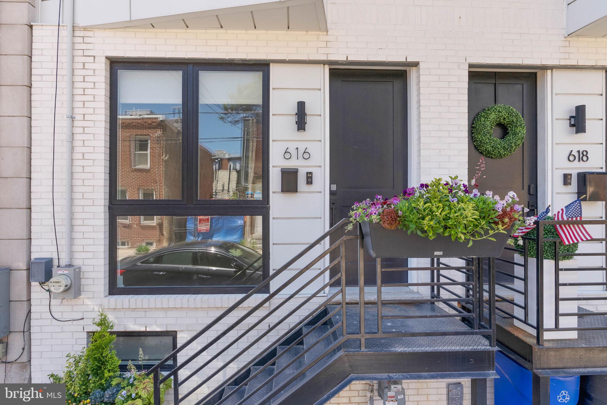 Welcome to 616 Dudley Street, a stunning contemporary home built in 2020, offering modern luxury, thoughtful design, and approximately four years remaining on the tax abatement—a valuable opportunity for today's buyer.

From the moment you arrive, the home's striking curb appeal and sleek architectural design make a lasting impression. Inside, you'll find 3 spacious bedrooms, 3 full bathrooms, and beautifully appointed living spaces enhanced by high-end finishes throughout. Floor-to-ceiling windows on every level flood the home with natural light, creating a bright and inviting atmosphere.

The open-concept main living area is designed for both everyday living and entertaining. At the center of the home is a spectacular chef's kitchen featuring a dramatic marble waterfall island, custom cabinetry on both sides, and abundant storage and workspace. The seamless flow between the living, dining, and kitchen areas creates the perfect setting for gatherings of any size.

Retreat to the luxurious primary suite, a true private oasis complete with a convenient marble wet bar, expansive walk-in closet, additional generous closet space, and a spa-inspired bathroom featuring a double marble vanity and oversized rain shower.

The finished basement offers high ceilings and a full bathroom, providing exceptional flexibility as a home gym, media room, playroom, guest suite, or home office.

Crowning the home is an incredible roof deck with breathtaking Philadelphia skyline views. With ample space for outdoor dining, lounging, and entertaining, this rooftop retreat is the perfect place to enjoy everything city living has to offer.

Combining modern construction, premium finishes, abundant natural light, versatile living spaces, stunning skyline views, and approximately four years remaining on the tax abatement, 616 Dudley Street presents an exceptional opportunity to own a turnkey home in one of South Philadelphia's most sought-after neighborhoods.

The listing contains a few photos that are virtually staged.