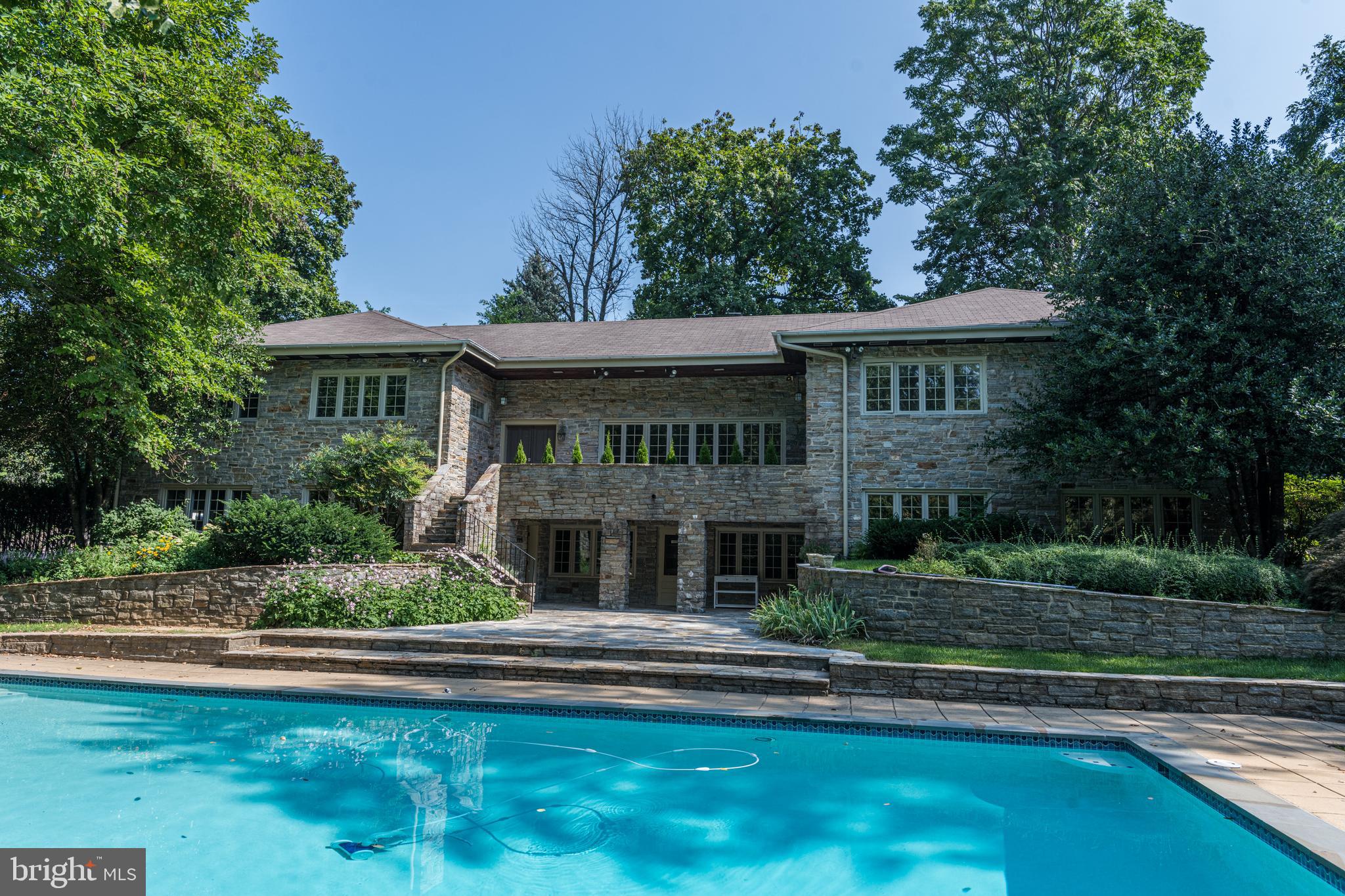 High on a Secluded Hill this Massive Stone Estate is a must see.  Once you drive up the private driveway you will be welcomed  to a leafy private sanctuary on almost a full acre.  The large in ground swimming pool  is surrounded by grass and rows of trees.  This amazing yard and pool  is the first thing that will amaze you but there is SO much more.  Once you come inside you will get lost in this house! There are enough bedrooms and bathrooms for your entire extended family and friends. Huge living areas and lots of intricate built ins. The gourmet kitchen is a show stopper with Viking appliances and expansive countertops and cabinetry, a large butlers pantry including additional cabinetry and a WFH desk space.  The attached dining room has room for a huge dining room table. The Classic game room has mahogany paneled walls, bench seating throughout and a high end wet bar and pool table. 6 Bedrooms , 6 full baths and 2 half baths! Schedule your appointment to see this beauty.  Located in Roland Park and Close to I-83, Mt Washington and Towson.  .