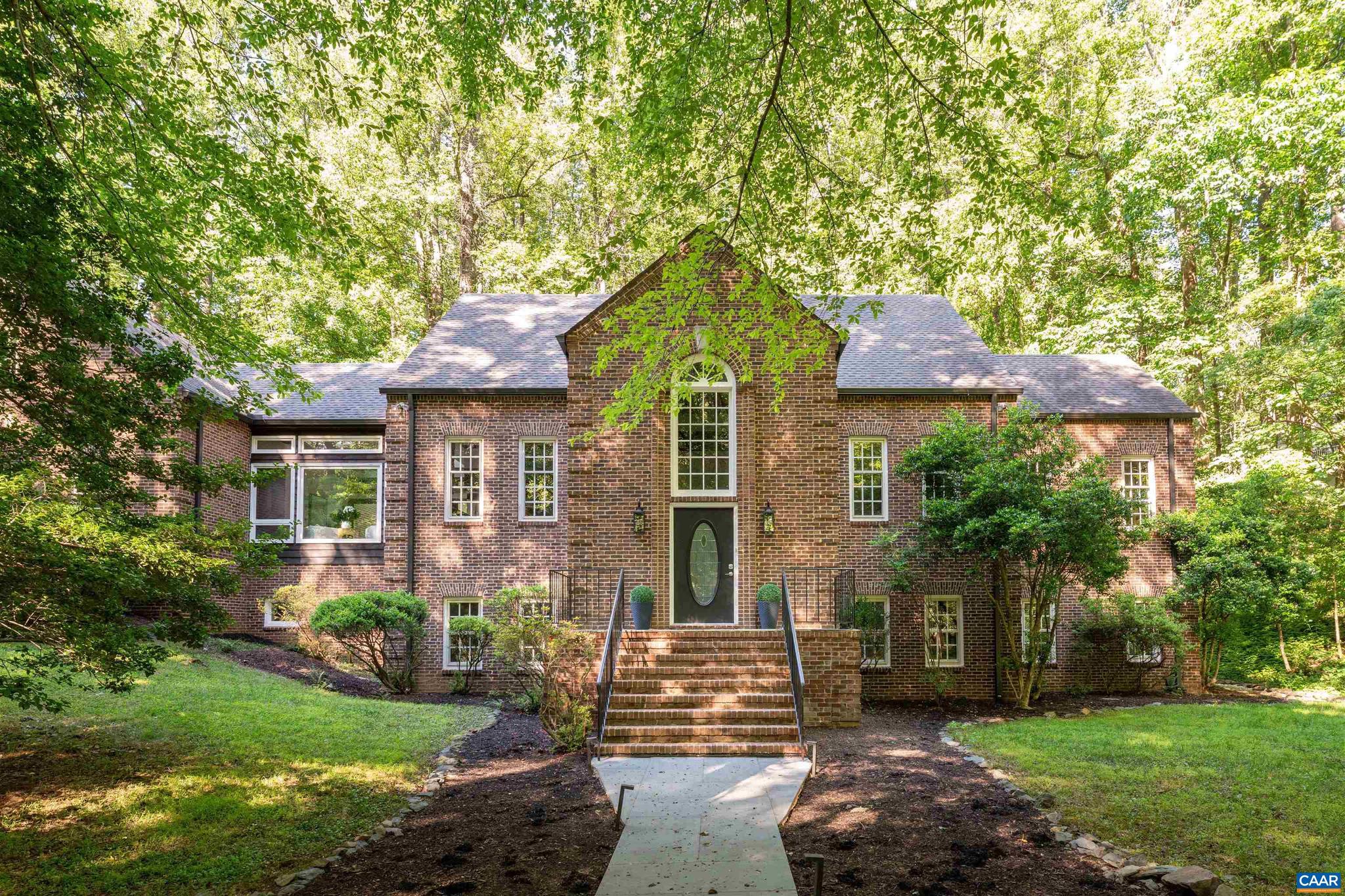 Stunning brick home is modern European! 10-13 foot ceilings, skylights and tall windows create a wonderfully light interior. Beautiful mature landscaping seen from every room. Private setting in peaceful Flordon with no through traffic. Enjoy your walks! 10 minutes to UVA and convenient access to downtown. Recent remodeling adds longevity and touches of today. Spacious main level primary suite easily accommodates king size bed & sitting area. A private office adjoins. Centerpiece of the living room is the handsome fireplace. Formal dining room seats 10. Recently updated kitchen has gorgeous cherry cabinets, quartz counters and stainless steel appliances. Adjoining sun room serves as a breakfast area and lounging space-here is the easy access to the private stone patio. Relax and entertain. Nature's beauty all around. Oversized 2-car garage. Storage rooms. Second floor is a bedroom, project space or 2nd office w/ full bath. Walkout terrace level has abundant natural light because it's almost entirely above ground. Two bedrooms each have en suite remodeled full baths. Family room's fireplace is a beautiful focal point. Game room with wet bar and doors to a patio. (See floor plans.) Find peace in the ground's hidden sanctuaries.,Cherry Cabinets,Quartz Counter,Fireplace in Family Room,Fireplace in Living Room