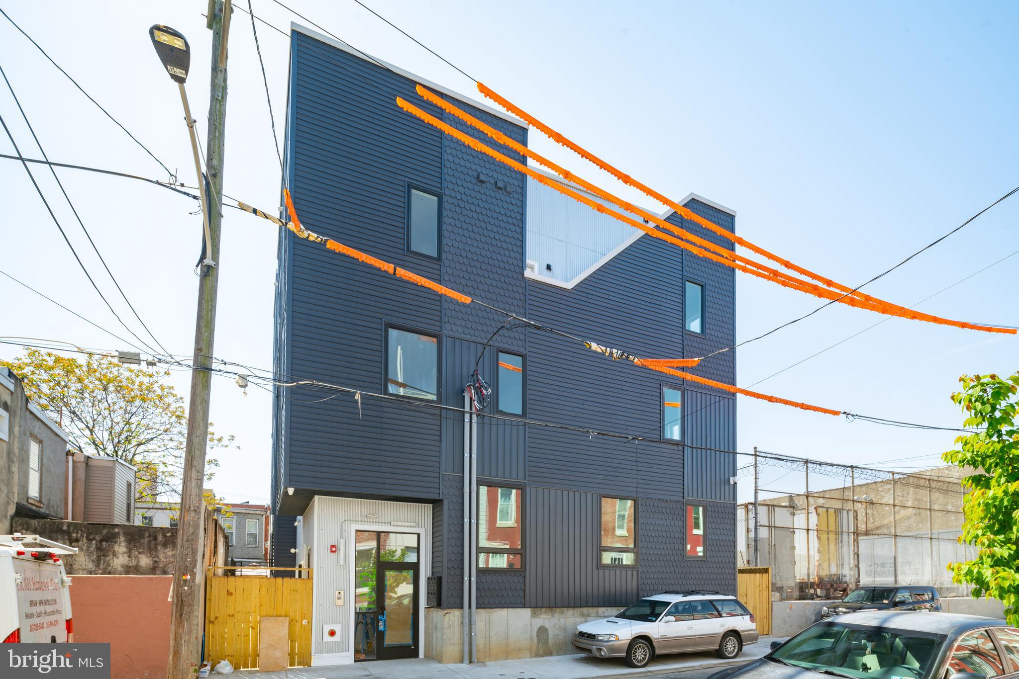 The Blue Building with the distinctive fish scale siding, 1842 E. Harold Street is a six-unit East Kensington multifamily property completed in 2022 and fully occupied at market rents. Offered at $1,585,000 with tax abatement through 2033, the building provides documented income from day one and aligns well with 1031 exchange buyers seeking stable, predictable cash flow.  The property is 100% occupied at market rents, generating $9,450 per month in gross income with a proven operating history since completion. This is not a lease-up opportunity. There is no vacancy story to underwrite and no pro forma guesswork-  the building is stabilized, documented, and producing from day one.  The unit mix includes three bi-level 2-bedroom, 2-bath units each with private roof decks; one 2-bedroom, 2-bath unit with private yard; one 1-bedroom, 1-bath unit with private yard and balcony; and one 1-bedroom, 1-bath unit with balcony. All six units feature private exterior space, in-unit washer/dryer, and central air — amenities that support strong tenant retention and long-term rent growth.
Located steps from the Huntingdon Station of the Market-Frankford Line and near the growing Kensington Avenue corridor between Lehigh Avenue and Front Street, the property benefits from transit accessibility and continued commercial momentum.
All zoning, licenses, leases, and operating expenses are fully documented. Profit and Loss statements and supporting financials are available for serious inquiries.
In addition to its current performance, the layout and outdoor amenities present potential long-term condominium sell-off optionality, though no condo declaration has been filed.
The fundamentals are already in place — stabilized, occupied, and built to keep doing exactly what it’s done since 2023: generate income.