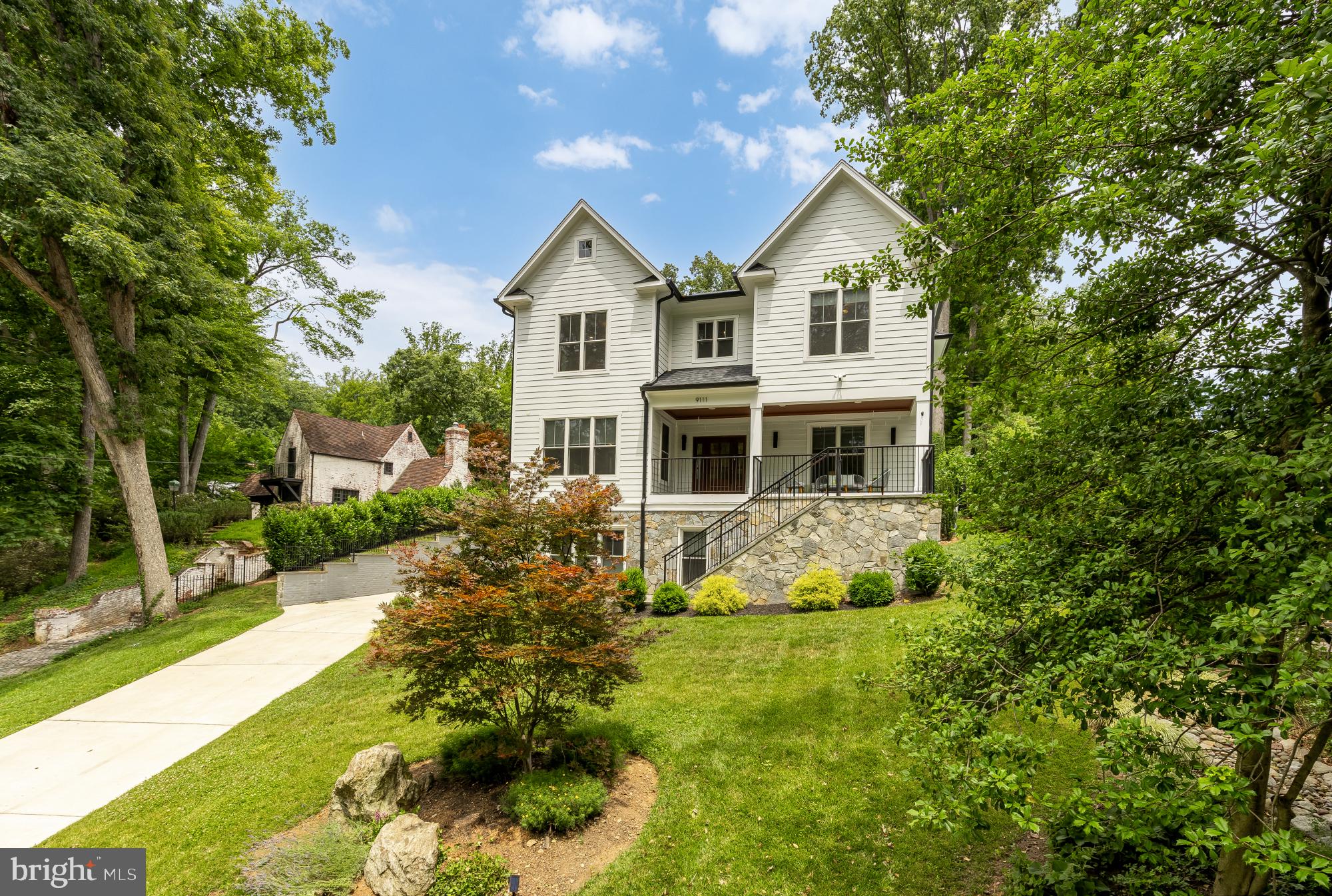 Why choose between modern construction, a spacious homesite, access to nature, and urban convenience when you can have all four?

Built in 2022 and set on an expansive 12,058-square-foot lot overlooking the natural beauty of Sligo Creek Park, this custom-built residence offers nearly 4,800 square feet of thoughtfully designed living space in one of the most connected and desirable locations in Montgomery County.

From the moment you arrive, it's clear this is not a typical builder-grade home. Every detail was carefully considered—from the generous room sizes and flowing floor plan to the quality finishes and long-term features designed to serve owners for decades to come.

Unlike older homes that often come with questions about aging roofs, outdated systems, and deferred maintenance, this home offers the confidence and peace of mind that come with modern construction. Built in 2022, the major components, systems, and infrastructure are virtually new, allowing you to focus on living rather than maintaining.

Inside, expansive living spaces are filled with natural light and designed for both everyday comfort and effortless entertaining. The open-concept main level creates a seamless flow between gathering spaces, while dedicated work-from-home and flex spaces provide the versatility modern households demand.

One of the home's most valuable features is its exceptional flexibility. The expansive lower level offers a private living area complete with a bedroom, full bath, family room, and kitchenette—ideal for multigenerational living, extended family, guests, an au pair or nanny suite, private office space, or countless other possibilities as your needs evolve.

Thoughtfully future-proofed, the home also includes a pre-framed elevator shaft, providing the opportunity for future elevator installation and making aging in place or accessible living a realistic option without major structural modifications.

Sustainability meets practicality with fully owned solar panels, delivering long-term energy savings and environmental benefits without the burden of leases or financing agreements.

Perhaps the most extraordinary amenity, however, lies just outside your front door. Sligo Creek Park serves as a daily extension of your backyard, offering miles of wooded trails, scenic pathways, open green space, and the tranquil beauty of the creek itself. Whether your ideal day begins with a morning run, bike ride, dog walk, or peaceful stroll beneath mature trees, this location makes an active lifestyle effortless.

Despite its natural surroundings, convenience is never far away. Enjoy easy access to the restaurants, shops, farmers markets, and community events of both downtown Takoma Park and downtown Silver Spring. The nearby Purple Line further enhances connectivity while representing a significant long-term infrastructure investment that supports both lifestyle and future value.

Opportunities to own a recently built custom home of this size, quality, flexibility, and location are exceptionally rare. 9111 Sligo Creek Parkway offers the space to live comfortably today and the foresight to thrive tomorrow.