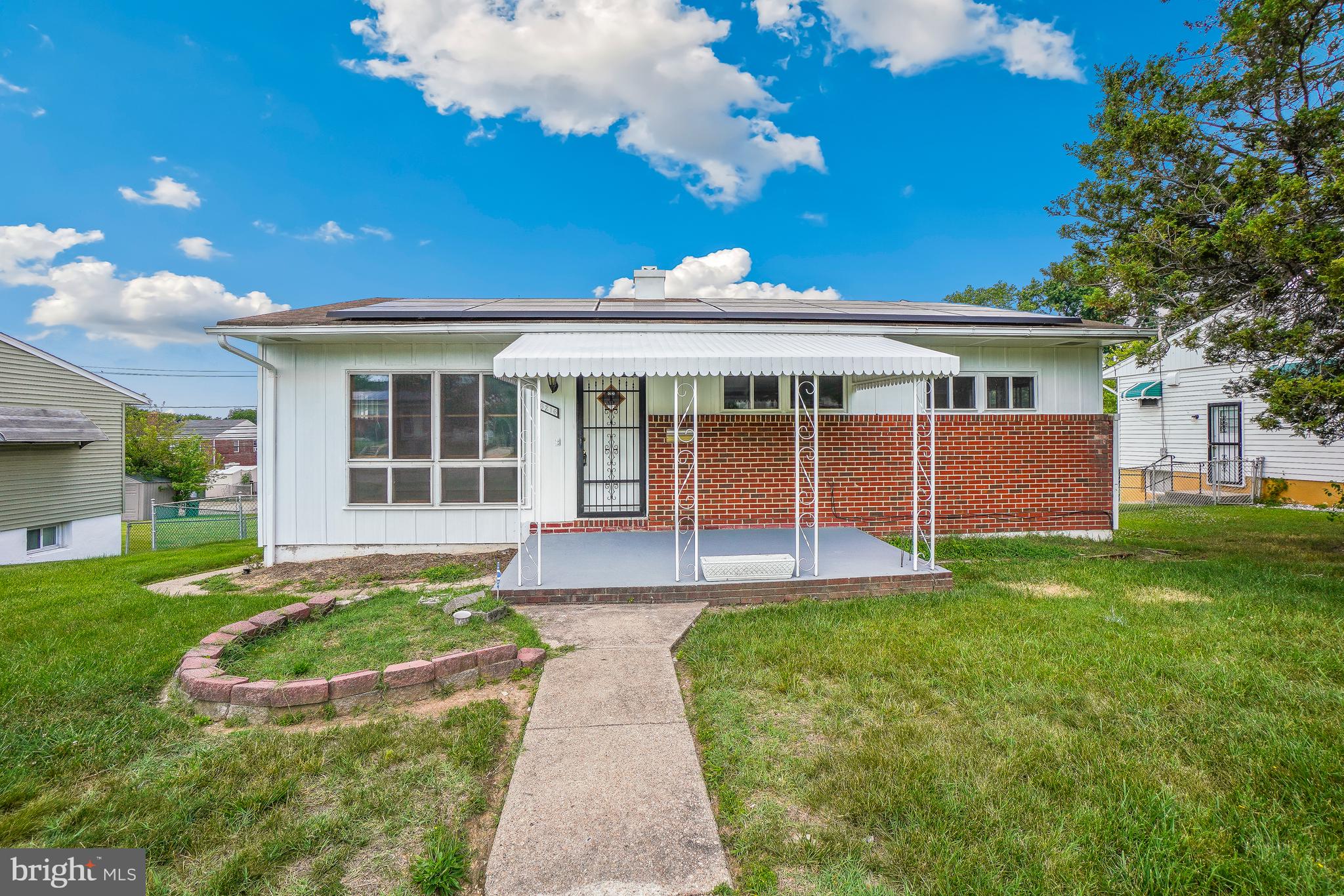 Light-filled brick-front rancher on a quiet, tree-lined block in Baltimore City's Hamilton Hills/Mount Pleasant area, offering one-level living with 3 bedrooms and 2 full baths, generous room sizes, and an abundance of natural sunlight throughout. Oversized picture windows fill the living room and bedrooms with sunshine, while freshly refinished hardwood floors and fresh paint brighten the main level. The kitchen offers ample cabinetry and counter space, with a separate dining room ideal for everyday meals and entertaining. Downstairs, a fully finished lower level with windows for natural light adds substantial additional living space, featuring a spacious wood-paneled rec room with custom built-in shelving and a kitchenette/wet bar area, along with a dedicated laundry area and a full bath, ideal for a home office, media room, or guest suite. Outside, enjoy a large, fully fenced rear yard with a concrete driveway off the rear alley offering parking for up to 3 cars, perfect for outdoor entertaining and everyday convenience. The location offers easy access to Harford Road and Perring Parkway for a quick commute into downtown Baltimore and beyond, and the home is located just minutes from Mount Pleasant Park and Golf Course, Herring Run Park, and MedStar Good Samaritan Hospital. This solid brick rancher, set on a leafy, tree-canopied block, offers comfortable space, abundant light, great bones, and an incredible yard, complete with a large covered brick rear patio ideal for outdoor dining and relaxing. Schedule your tour today.