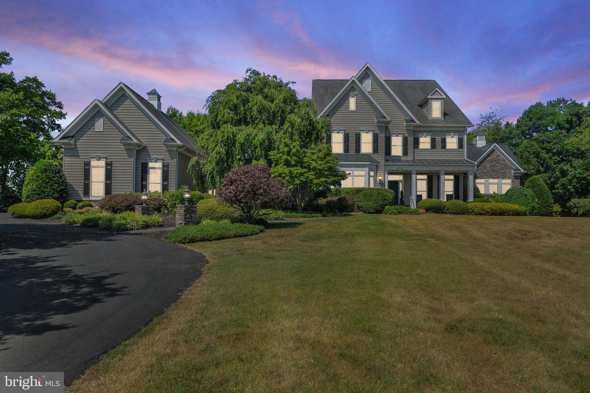 Welcome home to 16755 Birdham Dr., Hamilton, VA. This stunning home features 5 bedrooms, 4.5 baths, and 8,222 finished square feet, all situated on 3.28 private acres with no HOA.

From the moment you step into this custom-built home, you will be captivated by the extensive elevated level of upgrades included in this home, from the foyer to the magnificent rotunda with its curved staircase and wrought iron spindles. The spacious main level seamlessly flows to the upper and lower levels, starting with the large kitchen island with bar featuring granite countertops, 42” cabinets with under-cabinet lighting and backsplash, stainless steel appliances, double wall ovens, and more. The soaring 2-story family room boasts a tray ceiling, fireplace, and remote-controlled window coverings.

The home is adorned with perfected wood trim around the arched entryways, a beautiful mural-painted sunroom, accented niche wall inserts for your treasured displays, a formal living room with a fireplace, a formal dining room, an office, a butler’s pantry with a sink and beverage refrigerator, a walk-in pantry with additional wall cabinet pantry, and a dual staircase connecting the main level to the upper and lower levels. Additional features include extensive wide crown molding throughout, wainscoting, cherry hardwood floors, recessed lighting, ceiling fans, a laundry room with cabinets and folding area, dual front entrances from the front porch and mudroom, a fully furnished home theatre room that conveys with the property, a mural-painted playroom, a spacious 3-car garage, and a large outdoor kitchen and patio perfect for entertaining.

The main level includes an open foyer with cherry hardwood floors throughout this level, formal living room with fireplace, formal dining room, butler’s pantry, kitchen with island and bar, eat-in kitchen with access to the large outdoor patio and kitchen, walk-in pantry, additional cabinet pantry, family room, office, sunroom, and mudroom.

The upper level features a large foyer with cherry hardwood floors, a spacious primary bedroom with tray ceilings, a 3-sided gas fireplace, a coffee and beverage station, a walk-in closet, and a large ensuite with dual vanities, a soaking tub, a tiled shower, and a water closet. There are three additional bedrooms on this level, including a jack-and-jill bathroom for two bedrooms and a third bedroom with its own full bathroom.

The lower level includes dual staircases, a fully finished home theatre room complete with media equipment and theatre seating, a beverage room for relaxation, a custom mural-painted “Tree of Life” playroom, a recreation room with a partial kitchen and walkout access to the backyard, a fifth bedroom, and a full bathroom. 

The outdoor living space features an expansive flagstone patio, a custom outdoor kitchen with grill and “Green Egg grill and smoker,” a private backyard with a tree-lined background, and a private fenced tennis/basketball court. 

The home includes a propane gas home generator, a new asphalt driveway, and Xfinity high-speed internet. This home is conveniently located within walking distance of the W&OD walk/bike path, nearby shopping, restaurants, attractions, a commuter lot, and offers an easy commute to Northern Virginia, Maryland, and Washington, D.C. It is approximately 20 miles from Dulles International Airport.