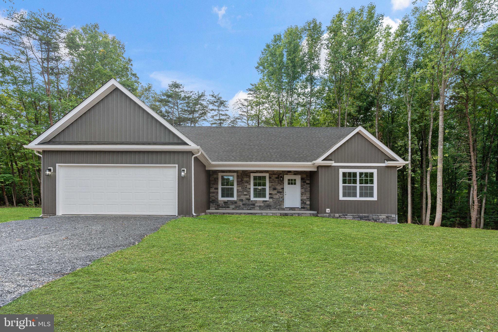 Stunning new construction home by Tim Hayslette Construction LLC. Situated on a large 2.13 acre lot in the Tomahawk area of Hedgesville in the highly sought after Berkeley County. This charming craftsman-style rancher offers a perfect blend of comfort and functionality. Step inside to discover an inviting open floor plan, where the kitchen seamlessly flows into the spacious living area, creating an ideal space for gatherings and relaxation. The master bedroom boasts a tranquil ensuite bath and a convenient walk-in closet, providing a private oasis for rest and rejuvenation. Bedrooms 2 and 3 are thoughtfully situated on the opposite side of the home, ensuring privacy and space for family members or guests.
With an unfinished basement and a 2-car garage, there's ample room for storage and future expansion possibilities. Enjoy the freedom of country living while still being within reach of amenities, all without the constraints of an HOA. For those seeking personalization, act fast! Don't miss the opportunity to make this peaceful haven yours! Schedule a showing today and envision the possibilities of creating your dream lifestyle in this beautiful home.