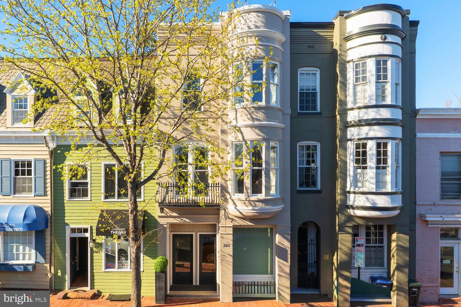 New on Market! A rare mixed-use four level offering in the heart of Georgetown’s coveted East Village, 2611 P Street NW presents a distinctive opportunity as a discreetly separated Georgetown Live/Work luxury property, with future flexibility to convert into a 4-level residence. The property is configured as a 1,220 SQFT (second and third floor) contemporary style residence plus a 2-level (main and lower) 1,013 SQFT studio, with interiors defined by natural light, clean architectural lines, and a cohesive contemporary European design approach.
 
Prominently positioned along a vibrant stretch of P Street, directly across from Rose Park and within close proximity to Georgetown’s most established dining and retail destinations, this four-level Victorian townhome dates to 1892 and is attributed to noted British architect Frederick G. Atkinson. The façade reflects Georgetown’s classic architectural language, with painted brick and curved bay windows on the upper levels. Inside, the home is configured as a contemporary style residence, with interiors defined by natural light, clean architectural lines, and a cohesive contemporary European design approach.
  
Rebuilt down to the studs in 2017, the property incorporates all new mechanical, electrical, and plumbing systems, along with Deltalight architectural lighting throughout, complete with fully integrated home automation and in-wall touchscreen controls. Refined interior finishes with exceptional attention to detail include custom Poliform-built feature walls and cabinetry throughout the main living spaces. The modern, professionally equipped kitchen pairs chef’s functionality with a Miele appliance suite that can be fully concealed when not in use. Innovative storage solutions are found throughout, complemented by intricate backlit Poliform library and closets.
 
The upper residence includes two private balconies, along with custom interiors featuring Poliform cabinetry, Rimadesio doors, Agape bathrooms, Poliform kitchen, expansive island with breakfast bar seating, ideal for casual dining and entertaining, Miele appliances, and Deltalight architectural lighting. A Crestron smart home system with integrated automation and security provides seamless control throughout. Immaculate, never-occupied residence conveys fully furnished, including custom furniture and Donghia window treatments, allowing for immediate occupancy.
 
The upper-level primary suite offers generous proportions and a calm, architectural aesthetic, with custom illuminated built-ins and a linear fireplace framed in Carrara marble. The adjoining Agape bathroom is designed with a restrained, monolithic approach, featuring a floating double vanity and a single pane of glass enclosing the water closet and walk-in shower, both finished in continuous marble slab.

This offering combines the scale and character of a historic Georgetown residence with inviting modern European-tailored interiors, all in one of Washington’s most established and sought-after neighborhoods.