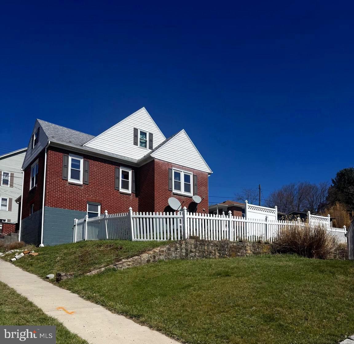 This lovely home is smack dab in the middle of Downtown Frostburg.  It's a spacious brick home with a fence for privacy, a large yard, a covered porch and deck to take in the  beautiful mountainous views! 
You'll find a large living and formal dining room just off the kitchen.  Both bedrooms are on the main floor as well as the primary bathroom with linen closet. The walkup attic could be finished for an additional bed/bath, play area, entertaining area or whatever your heart desires. The basement has tons of room for laundry, workshops, storage and has a convenient 2nd bathroom with shower stall. 
There's a parking spot in the front as well as the back and a shed for storage needs.