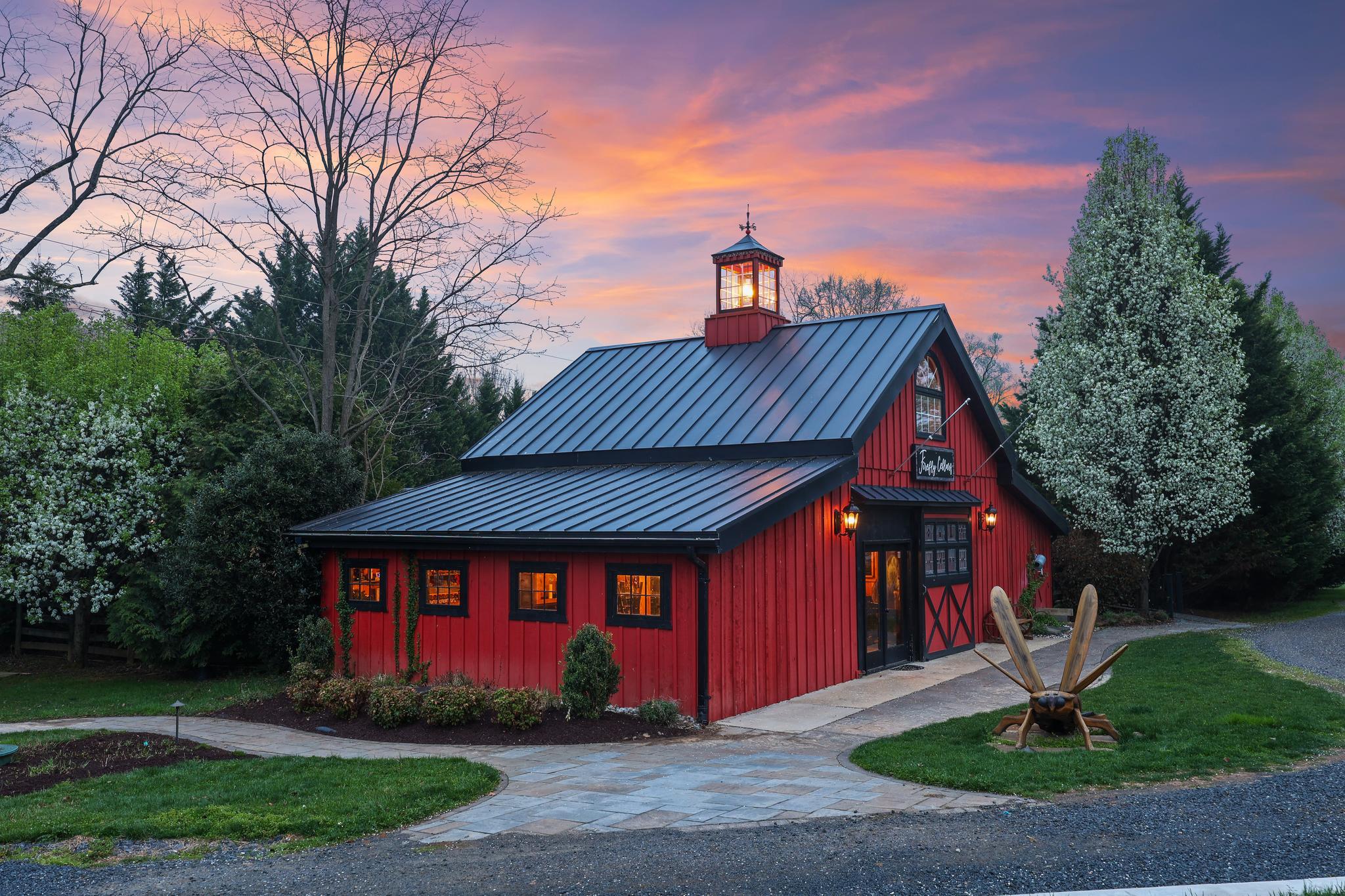 Perfectly positioned along Charles Town Pike, this is a rare opportunity to own a true destination property in Loudoun County with both high visibility and a scenic, private setting. Set on 3.5 acres backing to a picturesque 20-acre horse farm, the property offers a unique blend of accessibility, charm, and flexibility with dual entrances and parking for 50+ vehicles.

Originally designed and custom built with intention and craftsmanship, the property unfolds as a true destination experience. The main residence offers over 3,100 square feet of character-rich living space, complemented by a charming guest cottage, an expansive barn and tasting space designed for gatherings, and an additional detached structure that adds flexibility for retail, hospitality, or private use.

This is a property that adapts to your vision. Host weddings and private events under the lights, operate a boutique hospitality or retreat concept, create a multi-building short-term rental compound, or simply enjoy it as a private estate with the ability to generate income. The layout and infrastructure are already in place, allowing the next owner to step in and elevate the experience.

Outdoor spaces are where the property truly comes to life. A 1,200 square foot deck, fire pit area, and multiple gathering spaces create an unforgettable setting for entertaining, relaxing, or hosting guests. Approximately half an acre remains under vine, while recent improvements including new septic systems, updated HVAC, solar lighting, and infrastructure upgrades provide a strong foundation for future use.

Whether you are an operator, investor, or end user seeking a one-of-a-kind estate, this property offers a compelling combination of lifestyle, flexibility, and long-term opportunity in one of Northern Virginia’s most sought-after destinations.