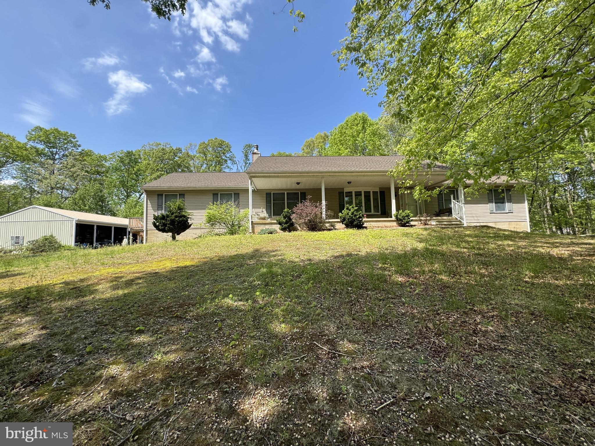 Welcome to this exceptional ranch-style home located at 174 Pine Tree Rd, Townsend, DE in the sophisticated and much sought-after Appoquinimink School District. Majestically nestled on an expansive 57.97-acre plot, this property offers unparalleled tranquility and solitude. Of the five bedrooms, one is part of a commodious in-law suite.  It has its own private entrance and deck for enjoying the outdoor air.  It has 1 bedroom, a full bathroom w/stand-up shower, full Eat-in kitchen and living room that overlooks the pond. This sprawling home boasts of 5 spacious bedrooms and 5 full bathrooms, blending comfort and versatility in every corner. Of the five bedrooms, one is part of a commodious in-law suite with a private entrance, full bathroom, and a separate kitchen, just perfect for extended family or guests. On the main level, the primary bedroom has its own full bathroom with a tub/shower.  The main kitchen has plenty of room for the cook in the house, great counter space, including the L-shaped counter, pantry, and lots of cabinets for storage.  From the kitchen open up the double french style doors to the 34x24 ft wood deck nestled at the back of the house perfect for entertaining family and friends.  It would be a great spot to host your next family reunion.  This home sweetly echoes the luxury of space. On the main level, the primary bedroom comes with its own full bathroom while an additional hallway full bathroom with tub/shower services the other two bedrooms. This home sweetly echoes the luxury of space.  Gleaming wood flooring in the formal dining room flowing through to the formal living room and down the hallway to the 3 bedrooms.  Outdoors, marvel at the picturesque views of the pond as you lounge on the 40x10 ft concrete front porch.  Beyond the lavish home, at the front entrance of the property, it comes with two single wide mobile homes, each with its own septic and both are connected with the irrigation well system from the main house.  A brand-new Heat pump system was installed in September 2023, ensuring your year-round comfort. The property is also equipped with a wood/coal boiler for primary backup heating, and it even has the option to connect to the hot water system, located in the basement. The home's construction features 6-inch exterior walls for enhanced energy efficiency, while a massive 88-foot-long attic with 10ft ceilings presents the potential to expand and customize your living space further. Practical amenities include a whole house central vacuum system w/attachments, whole house fan and pull-down attic steps located in the nice sized laundry room.   Accentuating this property's allure is its beautiful asphalt driveway that winds from the front of the property around the pond and through the woods up to the main house.  The 6 bay open pole barn is suitable for storage or as a workshop..  Great property for growing your own huge garden.  If you enjoy having your own fresh eggs, add egg laying chickens. Your options are endless. Its location just 50 minutes from Philadelphia International Airport and its easy access to SR1 to Delaware beaches and Ocean City, MD beach, makes it a perfect blend of tranquility and accessibility. Superior hospitals and shopping facilities are just minutes away.   Don't miss the opportunity to visit this property.  You won't be disappointed.   Schedule your appointment today!