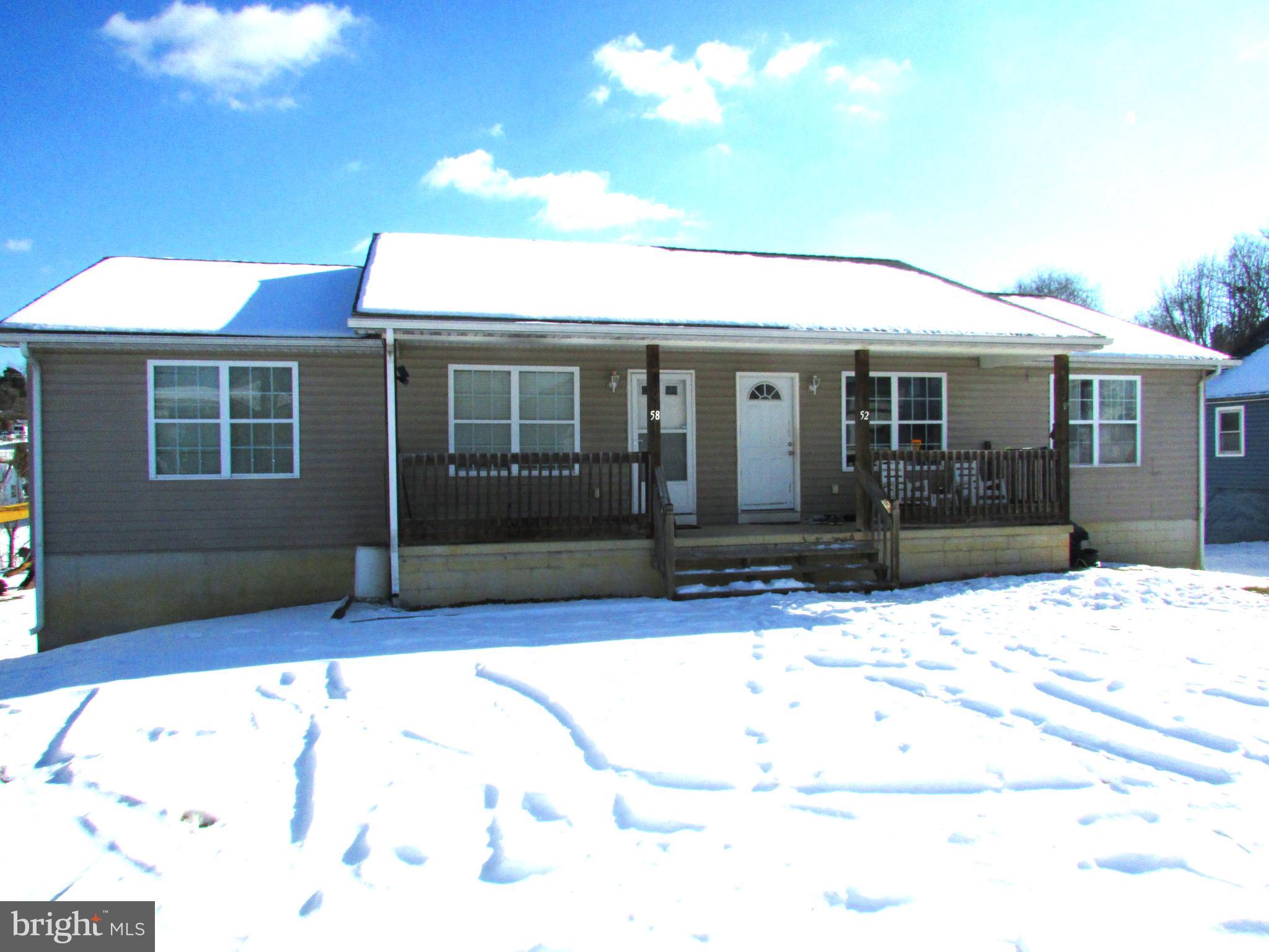 This great investment property has 2 (two) units with 3 (three) bedrooms and 2 full bathrooms - separate living rooms, eat in kitchens, laundry rooms and full basement (partially finished) with outside entrance to patio. Each unit is metered separately with electricity, water and sewer.  Ideal investment would be to live in one side and rent the other. Located close to schools, shops, Rt. 9, I-81 and downtown Martinsburg. Both sides are rented. Don't pass up on this great investment!   NOTE: #58 has a one-year lease with 10 months remaining, #52 is on a month-to-month lease