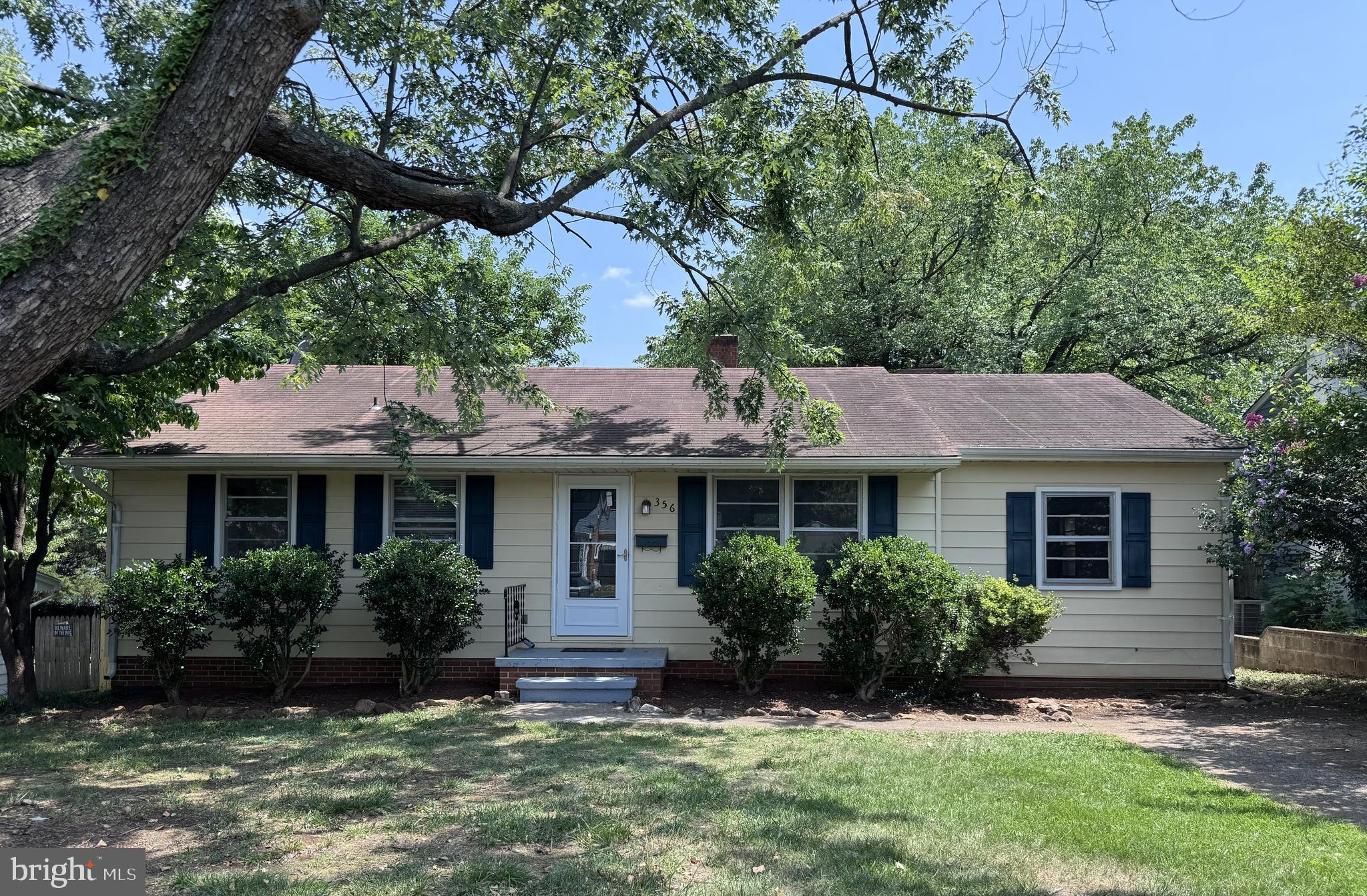 PRICED TO SELL!  This remodeled 3BR/1BA ranch offers comfortable one‑level living in a convenient in‑town location with off‑street parking.  Step inside to beautifully refinished hardwood floors that run through the living room, hallway, and all bedrooms. A spacious family room with an all‑brick wood‑burning fireplace and brand‑new carpet provides the perfect gathering space.  The kitchen blends modern updates with the charm of its original wood cabinetry and features new stainless‑steel appliances and countertop. The remodeled main bath shines with all‑new fixtures, custom tiled tub surround, and luxury vinyl tile flooring.  Additional improvements include Comcast cable, an updated electrical panel, and an electric heat pump (2012). The unfinished basement offers excellent potential for future finished space or storage.  Enjoy outdoor living on the covered patio overlooking the fully fenced shady backyard—ideal for pets, play, or gardening.  Sold strictly “as is.” Inspections are welcome for informational purposes only with an option to void.  Homes in this condition and price point are hard to find!  Schedule your tour today!