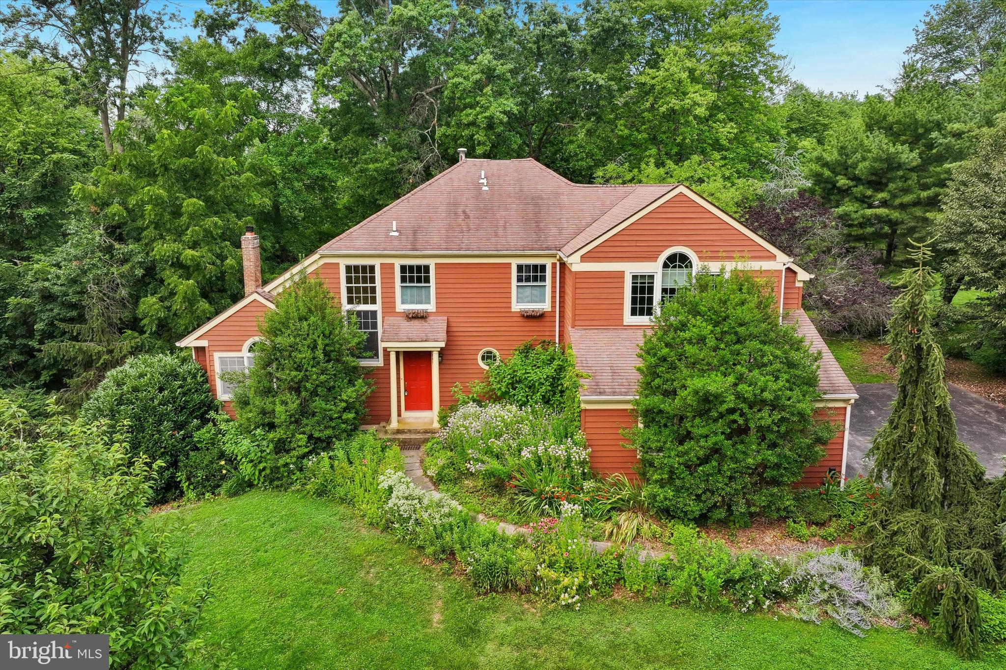 Welcome to 809 Irenic Court, a rare offering from its original owners, tucked at the end of a quiet cul-de-sac in East Norriton Township. This five bedroom colonial pairs classic comfort with something truly special: a backyard transformed into a woodland meadow and a front yard pollinator garden, lovingly cultivated with native plantings that invite birds and butterflies while asking very little of you in return. Imagine morning coffee on the expansive three season porch as the garden wakes up around you, or evenings by the gas fireplace in the impressive vaulted living room. Hardwood floors flow throughout both levels, and the kitchen with custom cabinetry opens to a sun drenched dining room that makes every meal feel brighter. A separate main floor office keeps work close but out of the way. Upstairs you will find four well appointed bedrooms and a full hall bath, including a primary suite freshly repainted in calm neutral tones with new light fixtures and an ensuite bath featuring both a soaking tub and stall shower. The finished walkout basement offers its own bedroom, full bathroom, and living room, an ideal setup for multigenerational living, guests, or a private retreat with direct access to the yard. An attached two car garage with generous storage completes the picture. With minimal mowing and thoughtfully designed low maintenance landscaping, 809 Irenic Court gives you more than a home with a yard. It gives you your own personal ecological oasis, ready for the gardener and outdoor enthusiast in you to simply move in and enjoy.