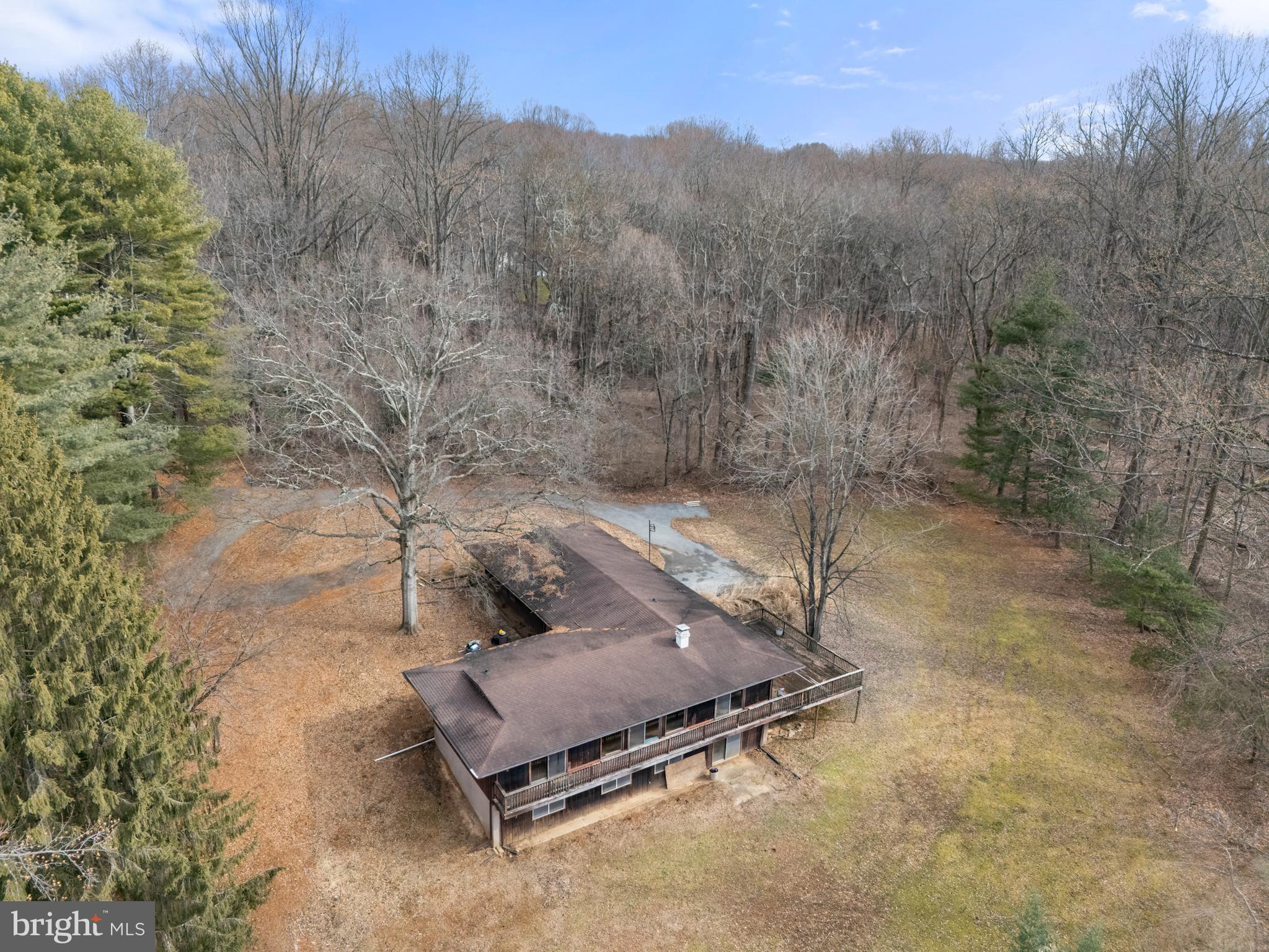 This charming, ranch-style home sits on a sprawling almost 3-acre lot, offering unparalleled privacy and endless potential. While the home may need some updating, its generous layout provides plenty of room to grow and personalize. A peaceful pond graces the property and can be reclaimed to enhance the serene atmosphere with its tranquil waters. The wrap-around deck is perfect for enjoying the outdoors and offers ample space for entertaining or simply relaxing while taking in the natural surroundings.  A home office with separate exterior entrance located off the garage.  Great for a self-employed individual with the need to keep work vehicles on site. With a little TLC, this property could become your dream retreat, nestled in a quiet, secluded location that's hard to beat.