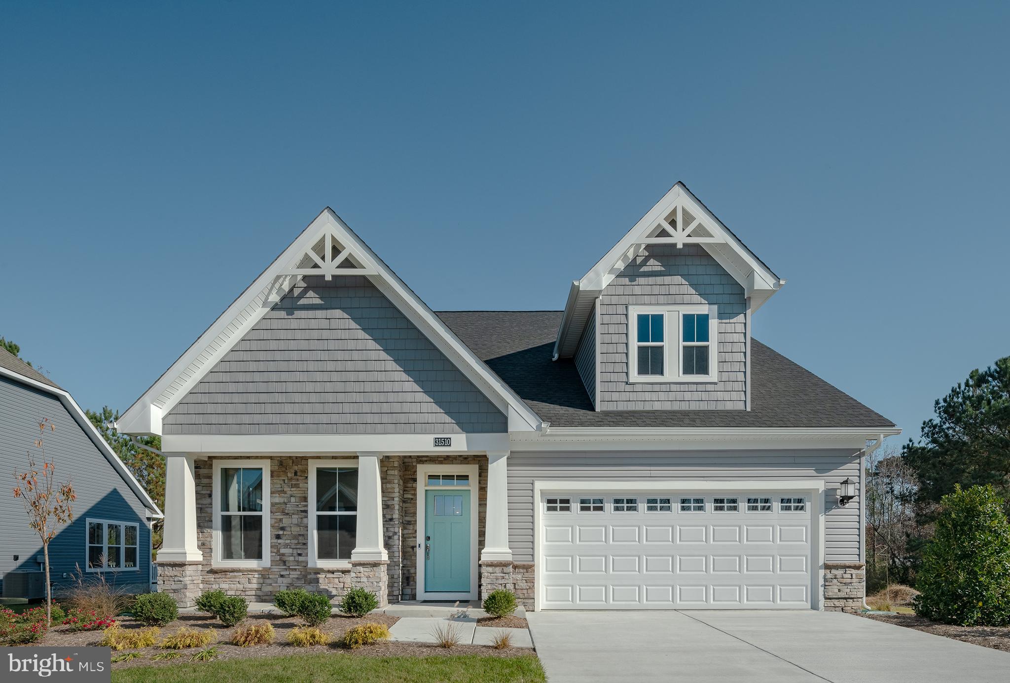 Coastal living at its finest with peaceful pond views and designer finishes throughout! This former model home offers like-new construction and a thoughtfully designed two-story layout ideal for full-time living, vacationing, or entertaining guests. The first floor features an open-concept great room, dining area, and beautifully appointed kitchen, along with a versatile flex room perfect for a home office or den. Tucked privately at the rear of the home, the spacious first-floor primary suite provides a relaxing retreat overlooking the water.  Upstairs, a generous loft creates additional living and entertaining space, complemented by two guest bedrooms, each with walk-in closets. Perfectly positioned on one of the premier homesites in the community, this never-lived-in home captures serene pond views from the deck and offers the advantage of brand-new living without the construction wait.  Residents of Milos Haven enjoy resort-style amenities including a swimming pool, bathhouse, sidewalks, snow removal, trash and recycling service, and lawn irrigation. Ideally located just minutes from the beaches of Ocean City, Fenwick Island, and Bethany Beach, as well as Tanger Outlets, local dining, golf, and Fenwick Island State Park, this home offers the perfect blend of coastal comfort and convenience.